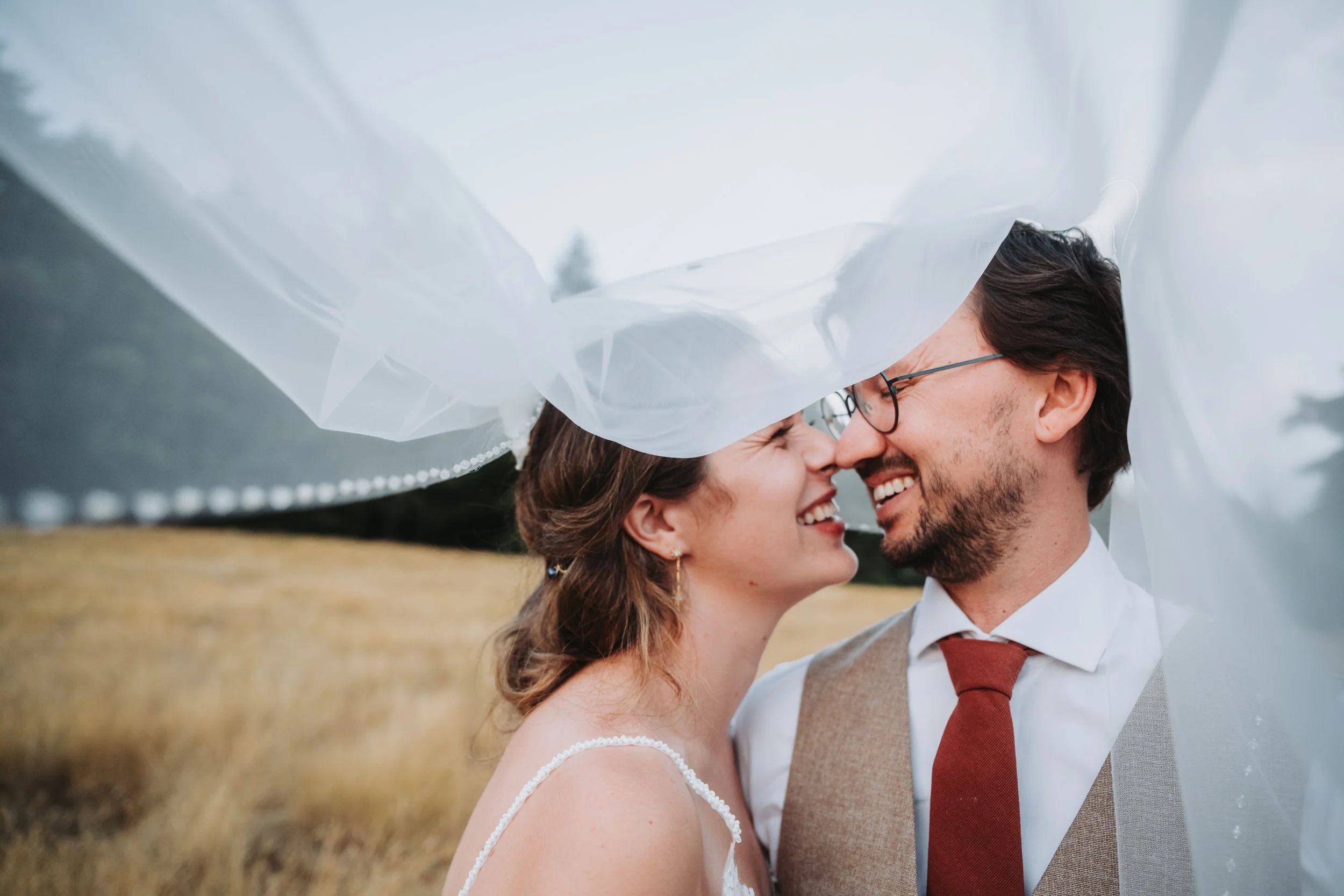 Bride and groom under a veil on Salt Spring Island 