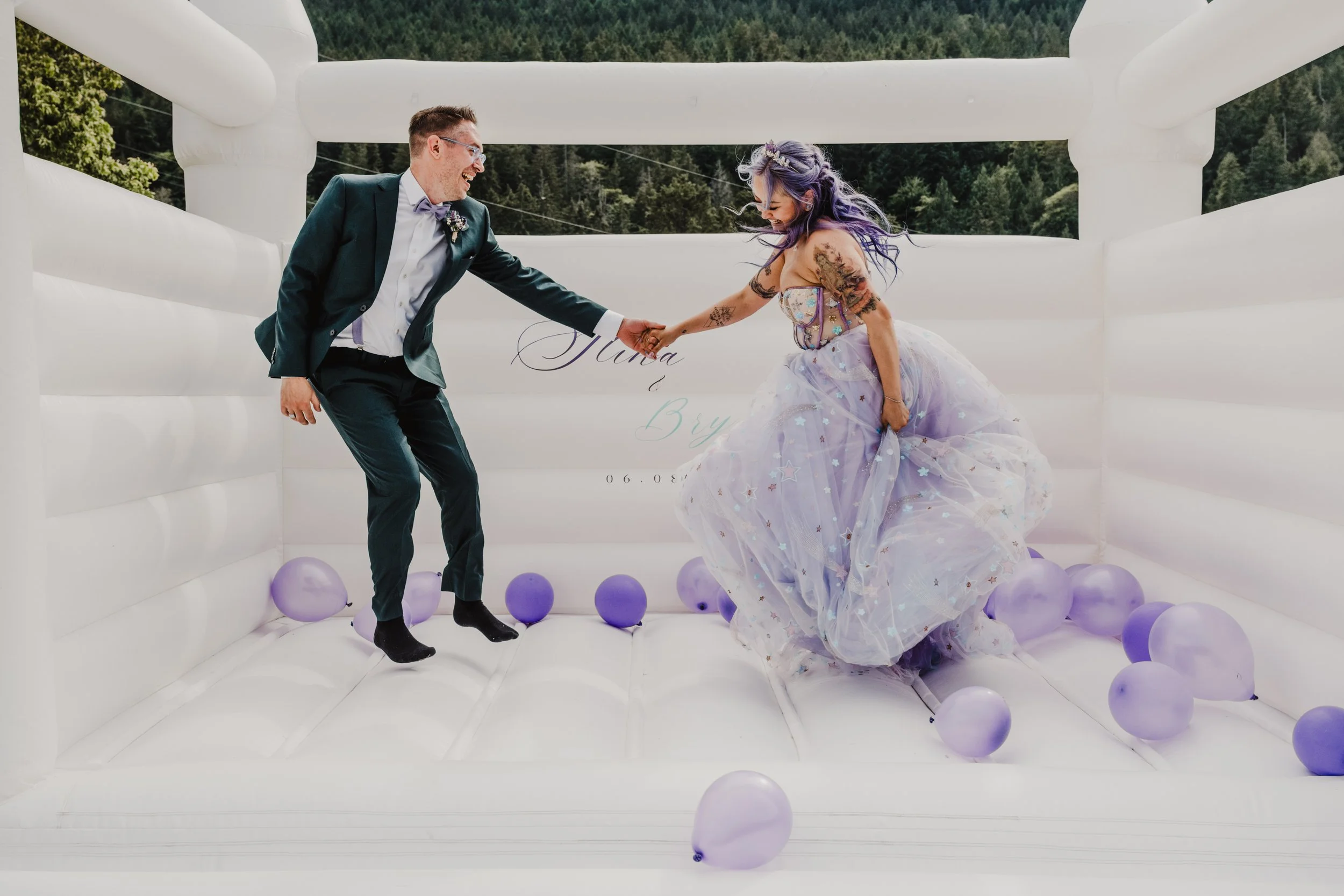 Bride and groom in bouncy castle on Vancouver Island 