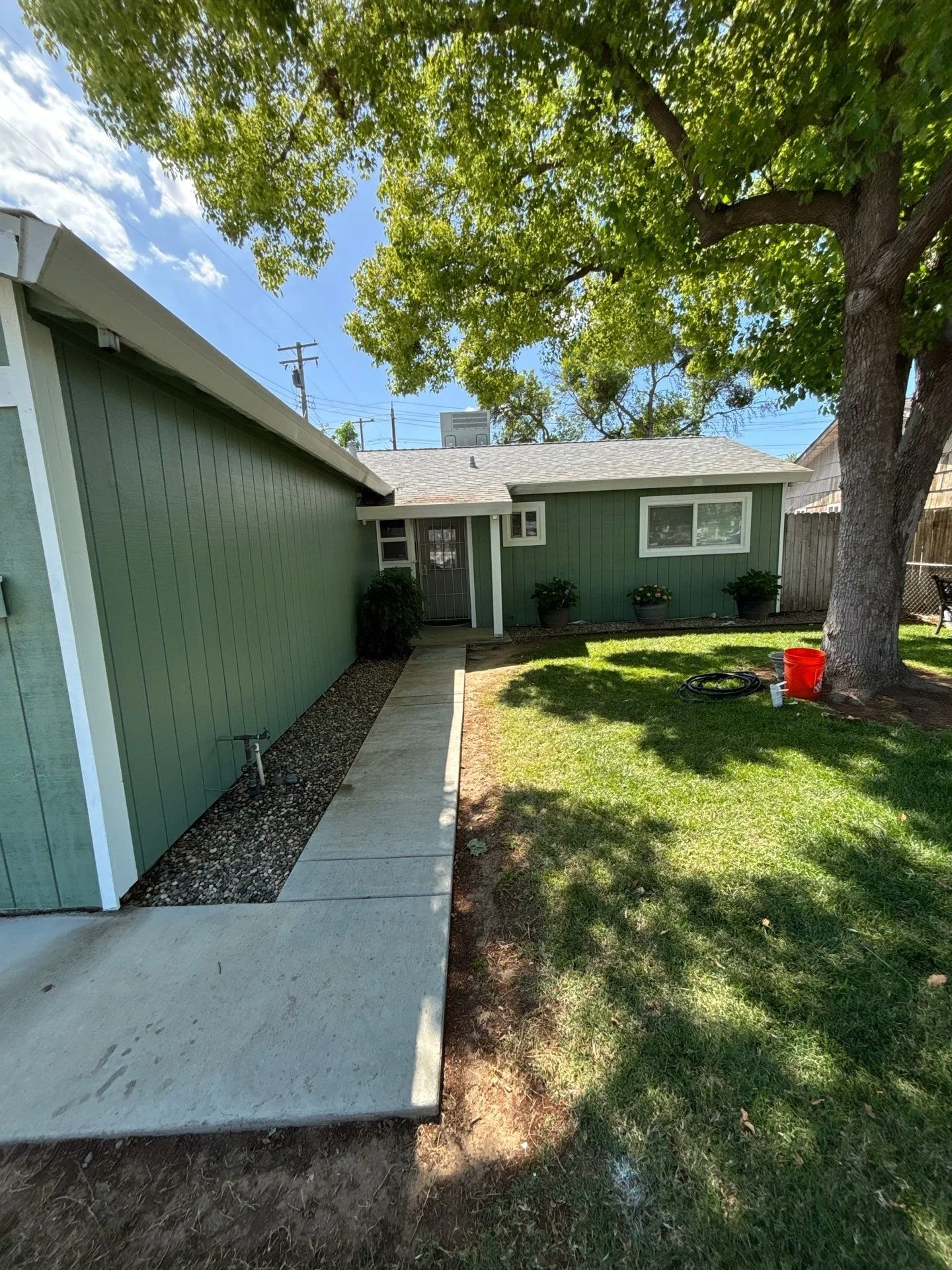 Finished new siding painted green with white trim on a Rio Linda home