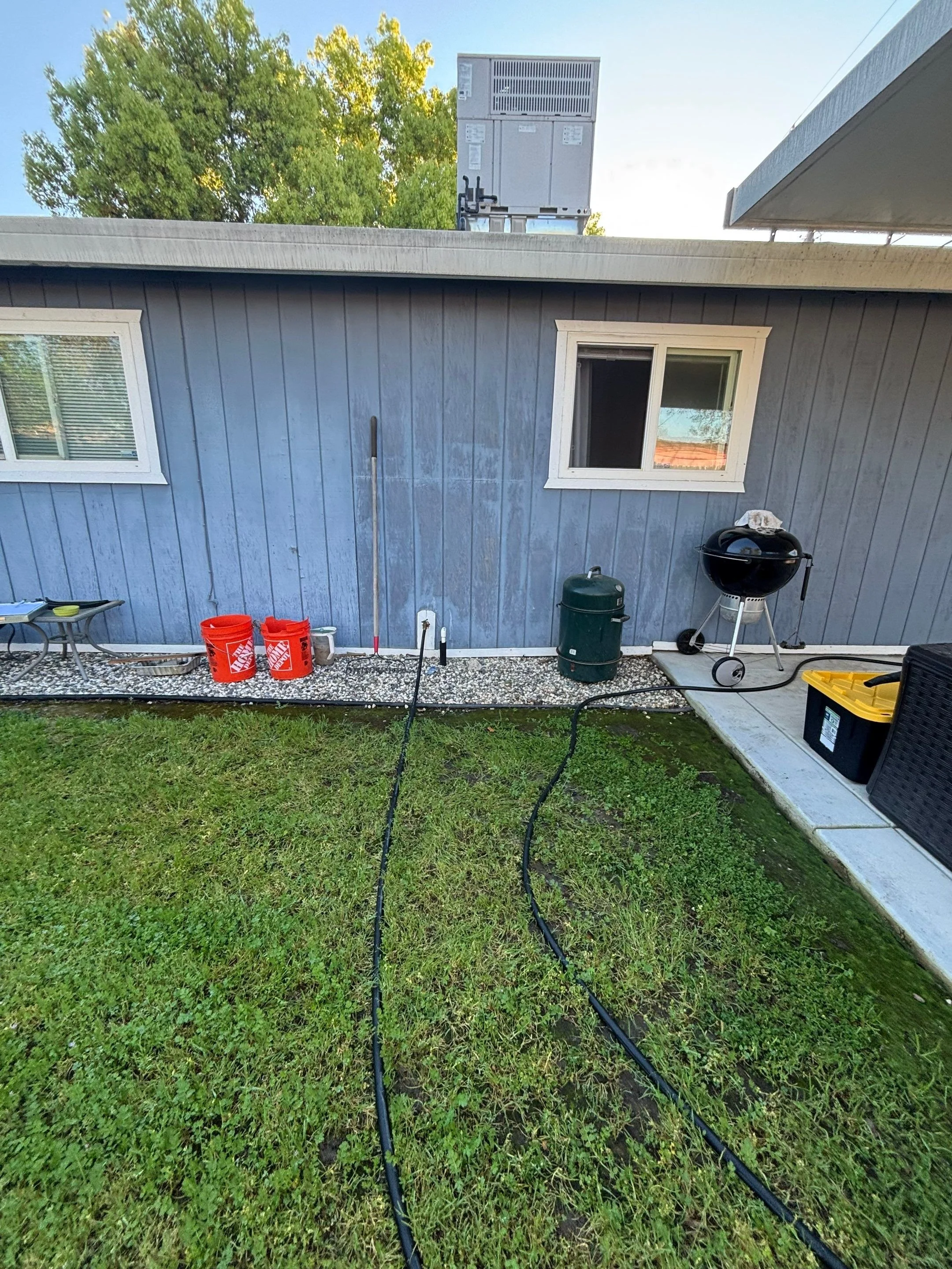 Old blue-gray siding before siding replacement in Rio Linda