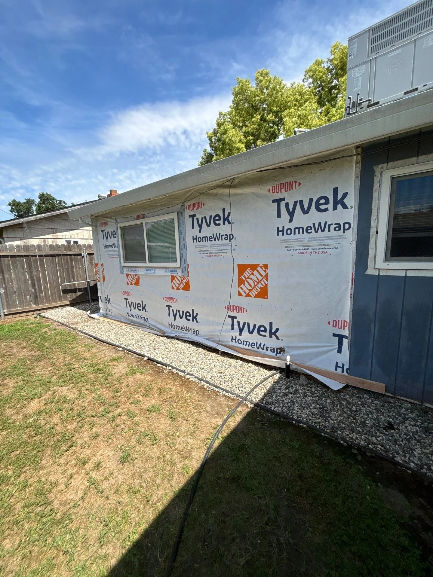 Walls wrapped in Tyvek house wrap during siding replacement in Rio Linda