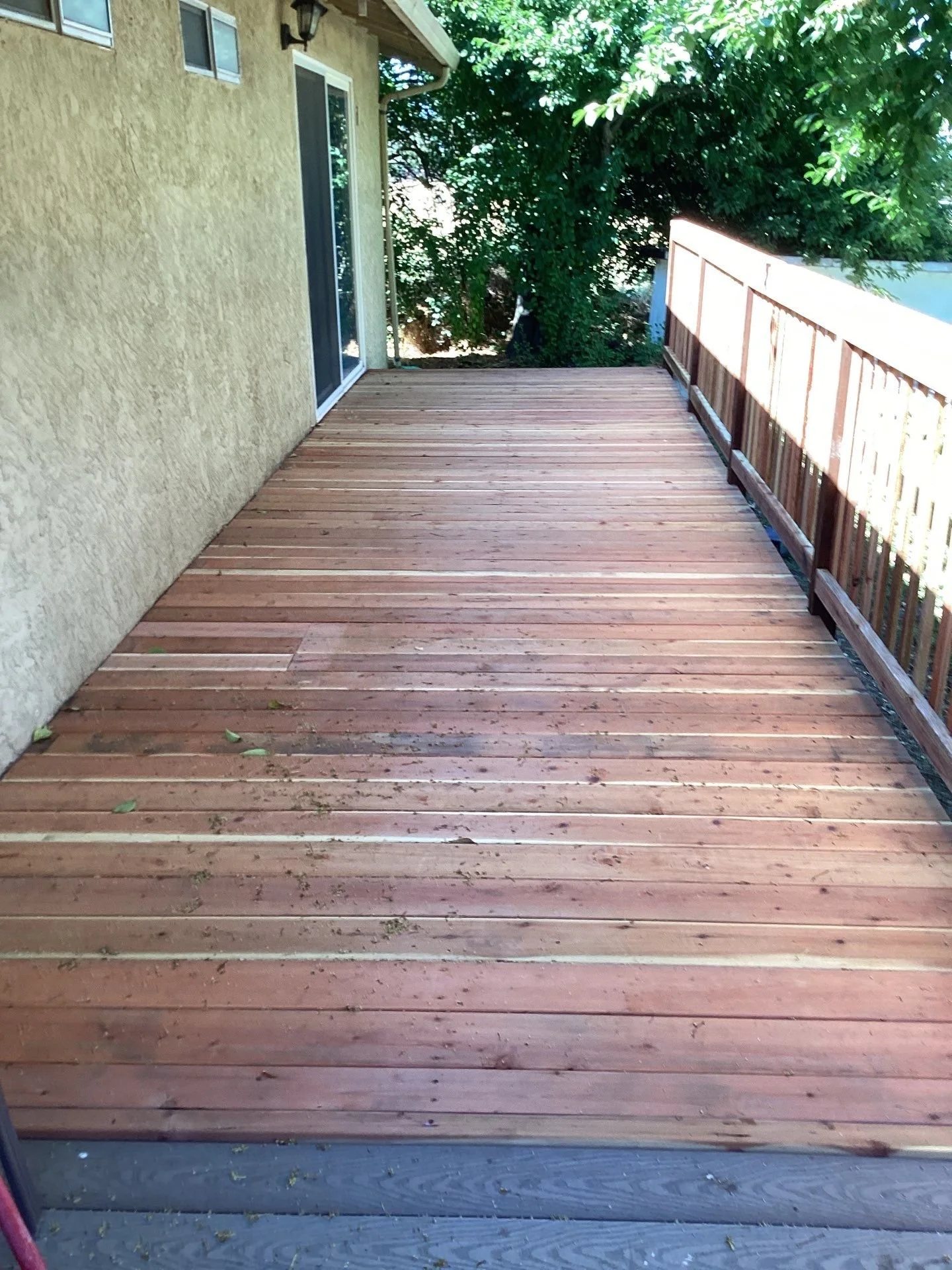 Finished rebuilt redwood-tone deck and ramp in Sacramento