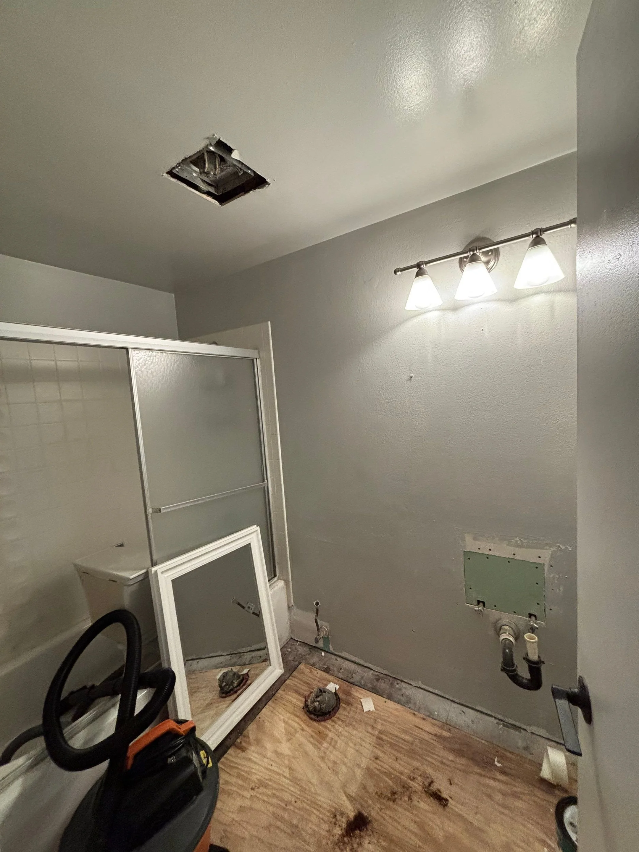 Bathroom floor torn out to the subfloor before remodel in Rocklin