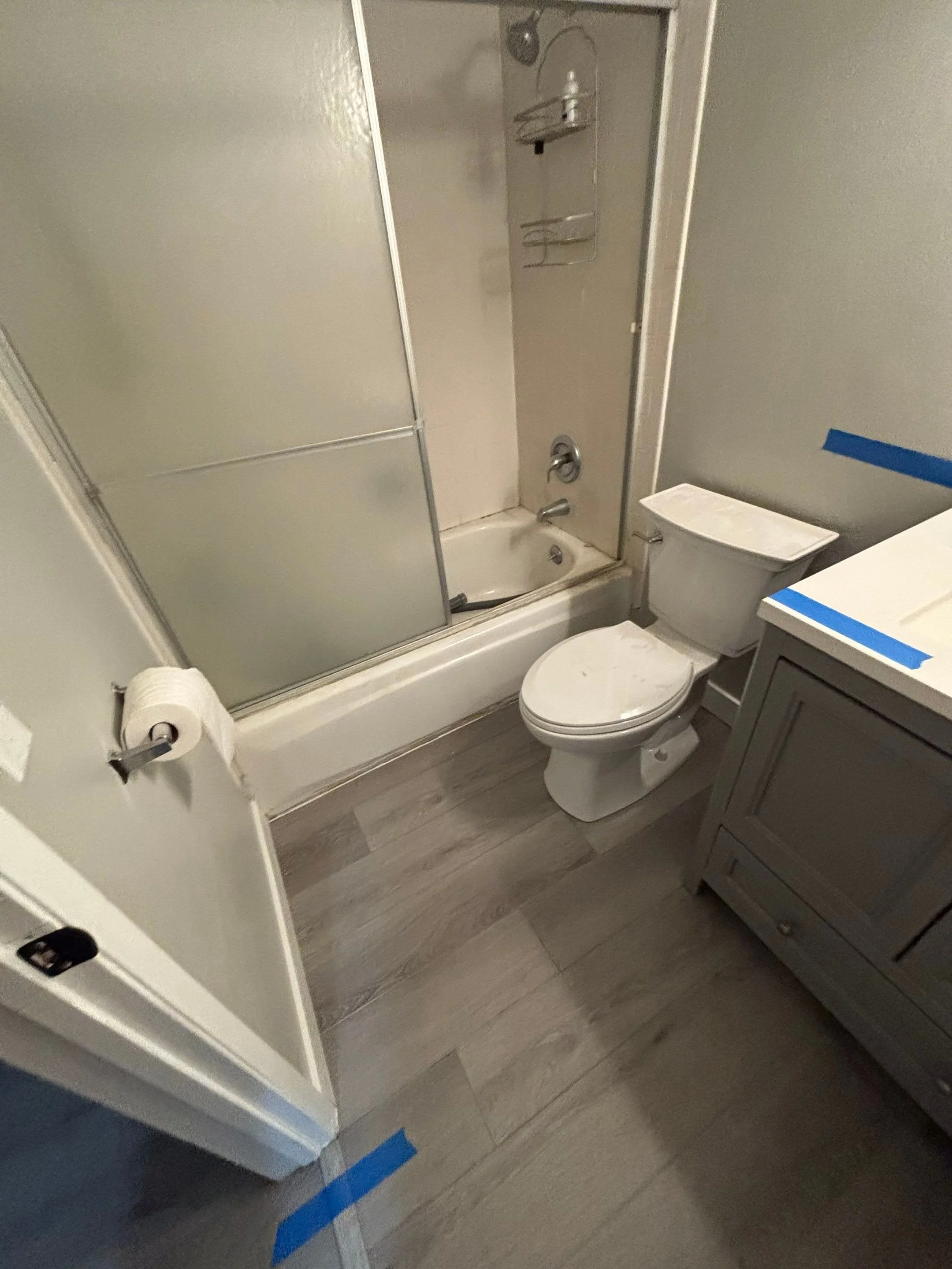 New bathroom flooring by the toilet and tub after remodel in Rocklin