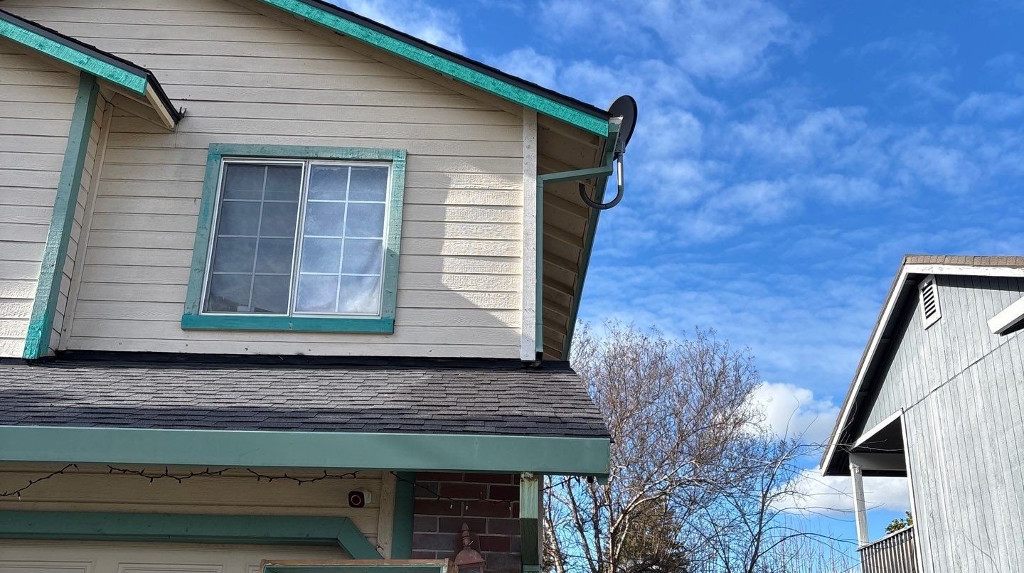 Finished siding and trim on a two-story home in Antelope after repair
