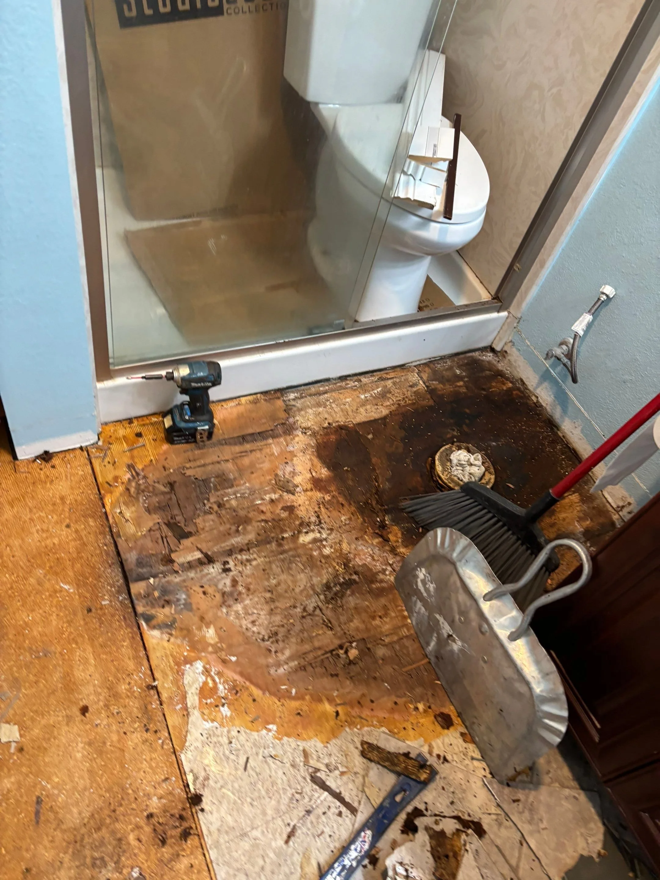 Water-damaged subfloor at the shower and toilet in a Sacramento bathroom