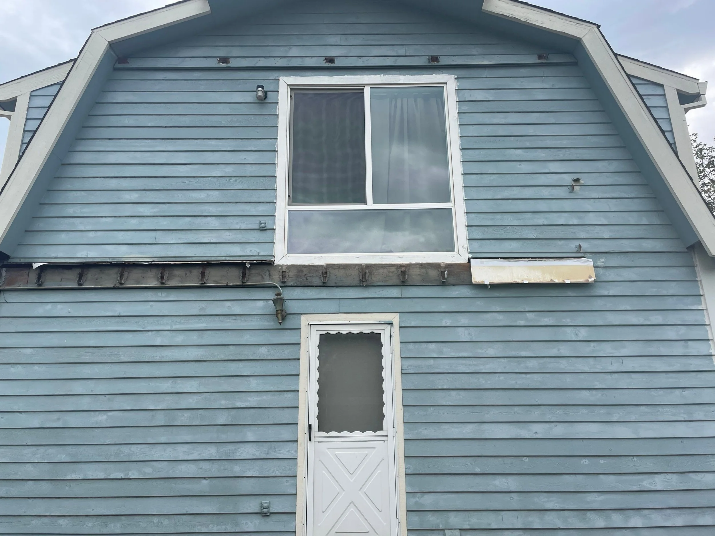 Back wall of a Rio Linda home with old siding before deck and siding work