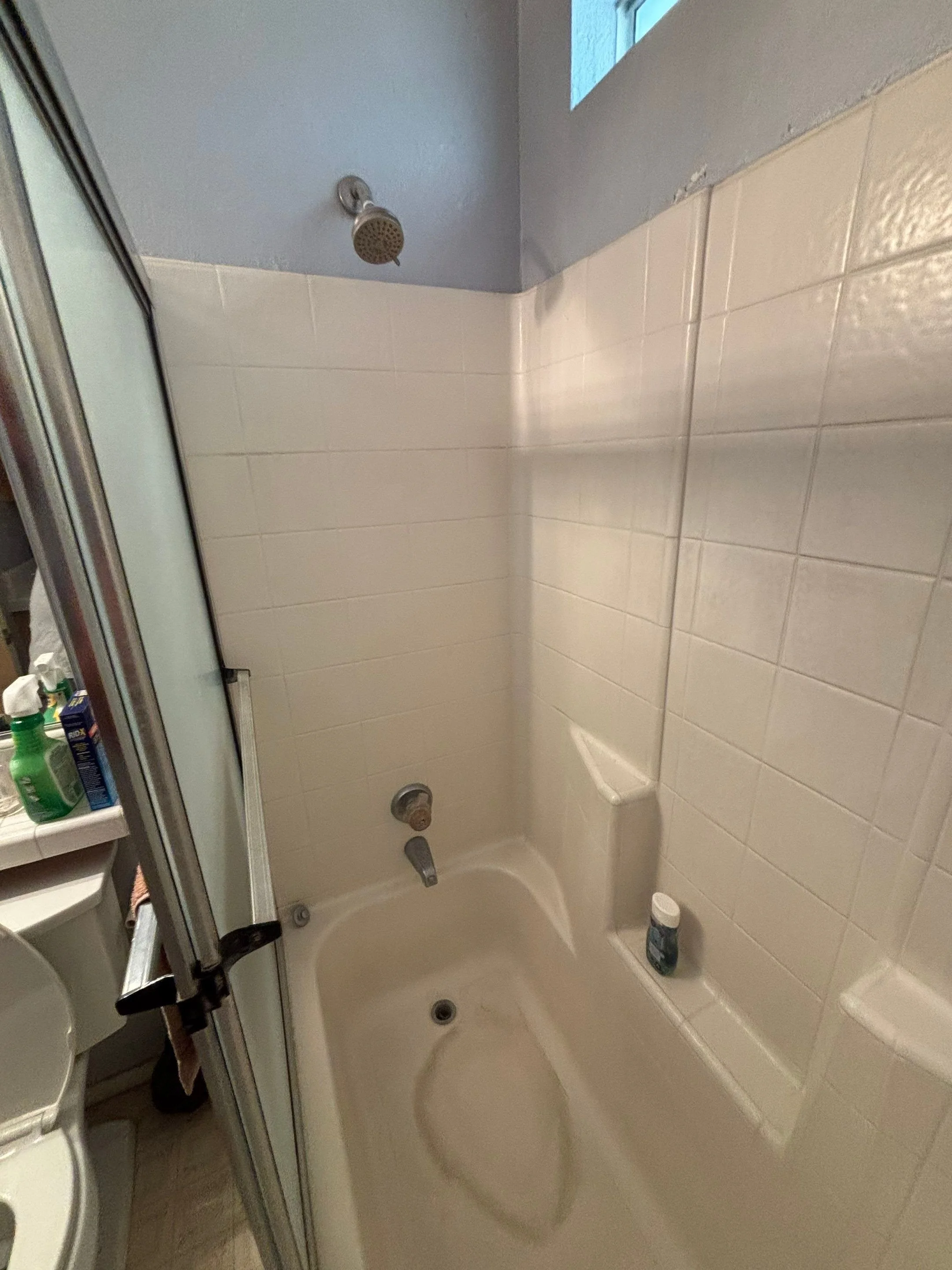 Old tiled bathtub with sliding door before the bathroom remodel in Rio Linda