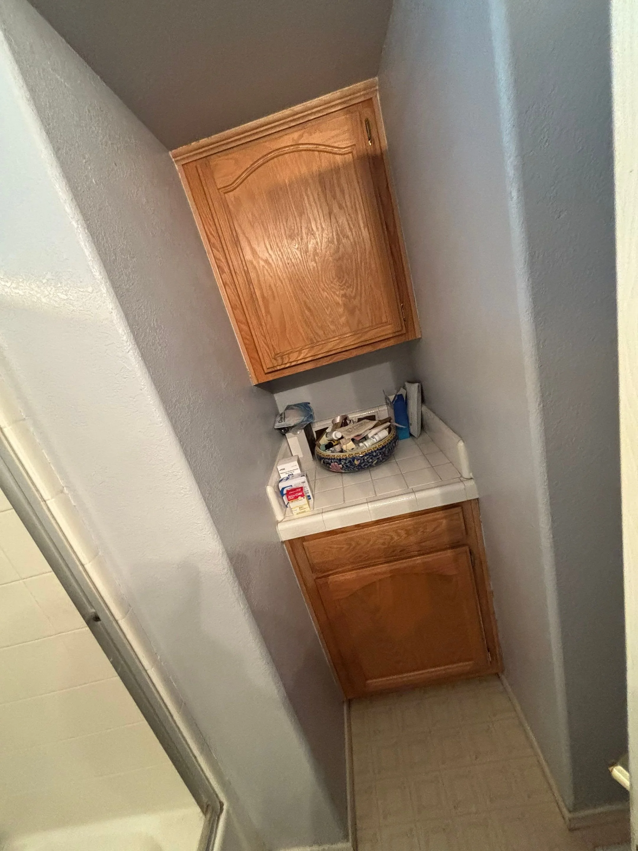 Dated oak vanity and cabinet before the Rio Linda bathroom remodel