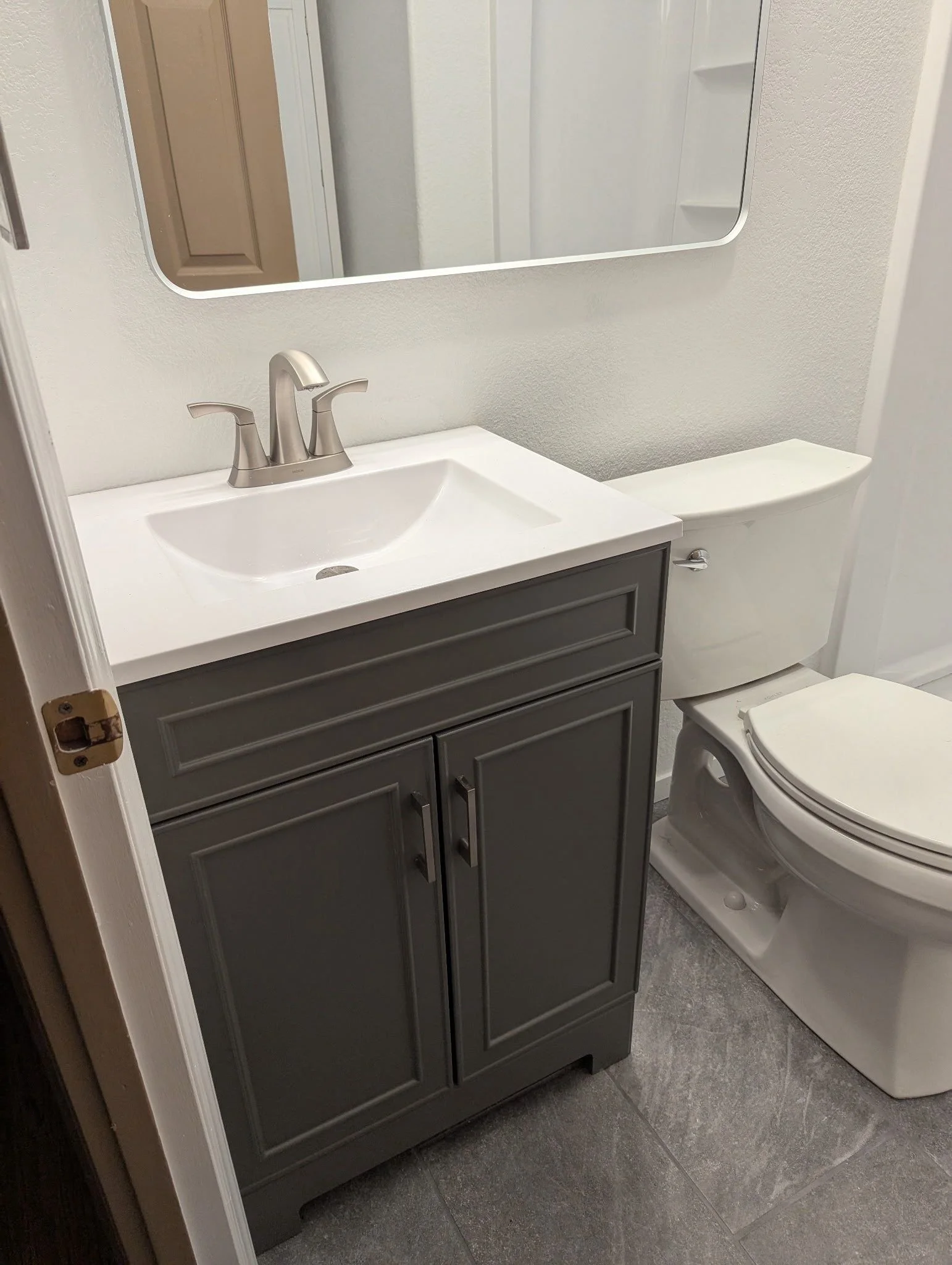 New gray vanity with white top and brushed nickel faucet in Rio Linda