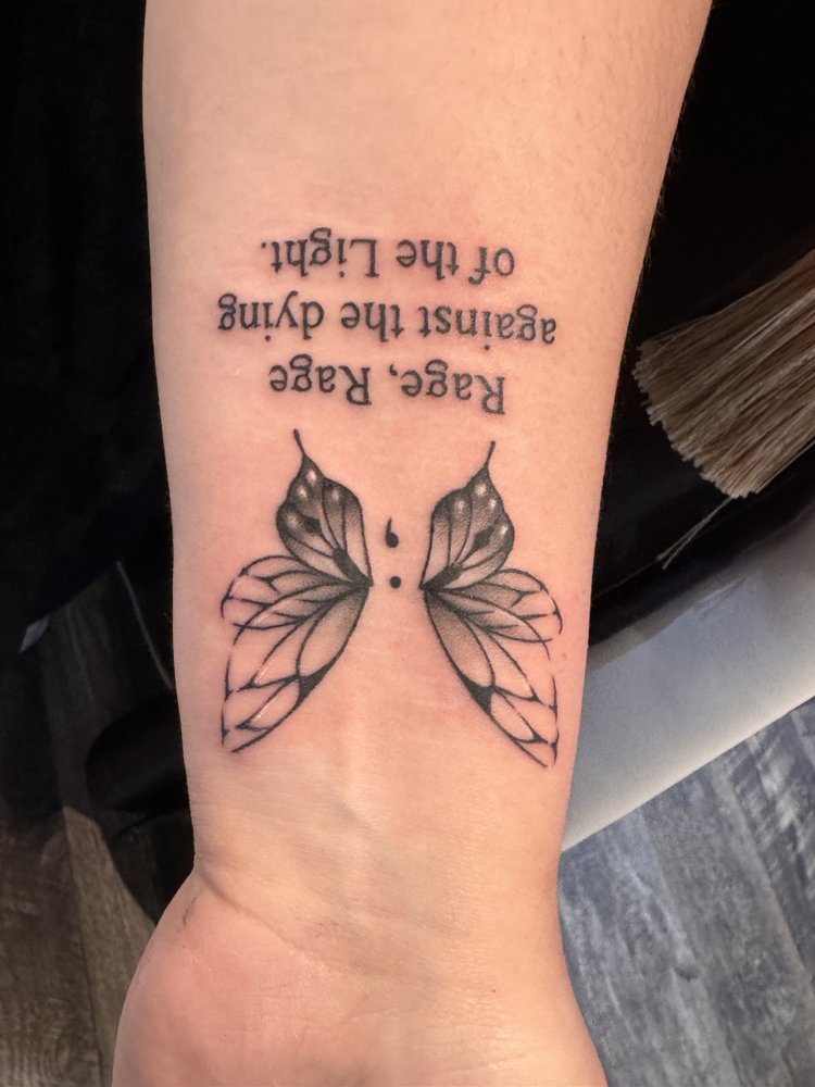 Butterfly and script tattoo by Daniel