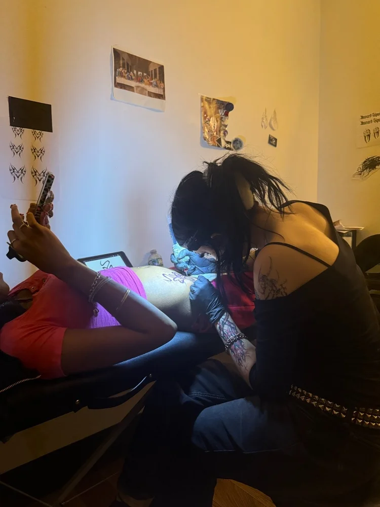 Summer tattooing a client at Red Ink Tattoo Studio