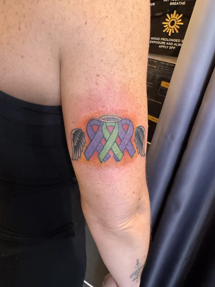 Color winged heart with halo tattoo by Daniel