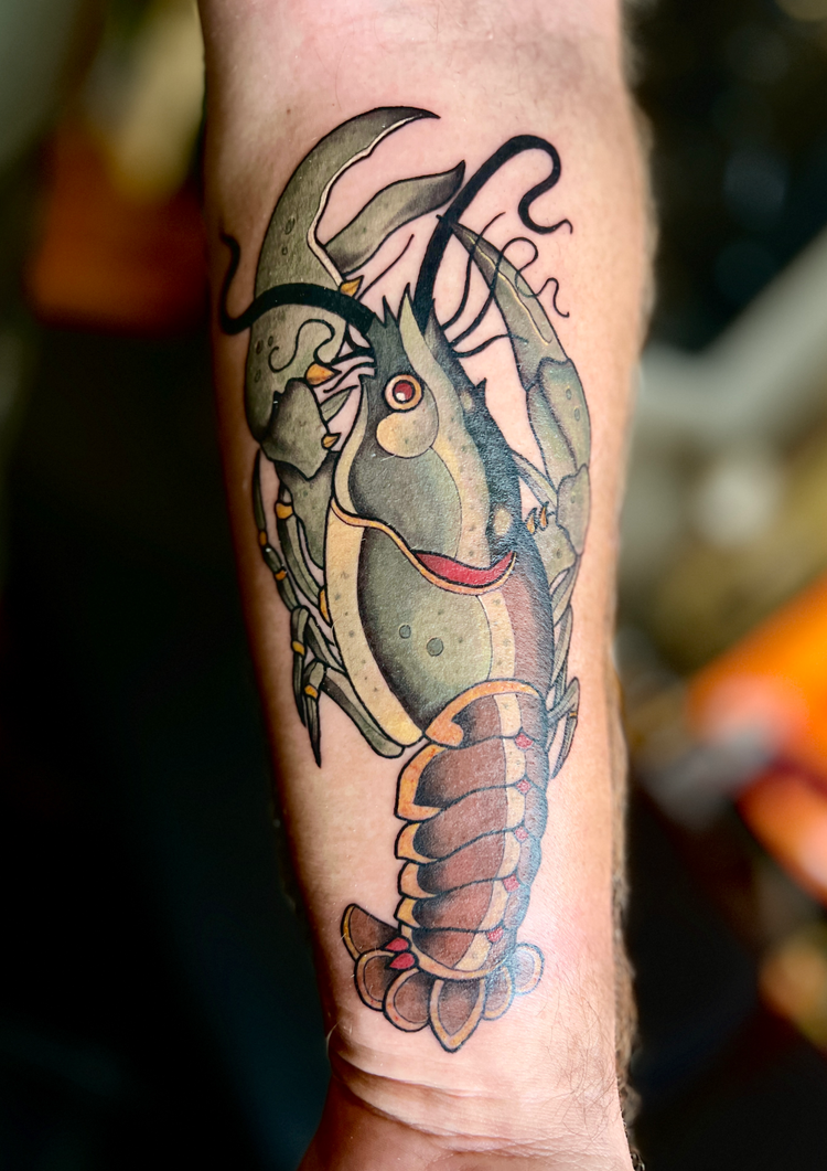 Colorful cartoon shrimp tattoo on a forearm by Alex