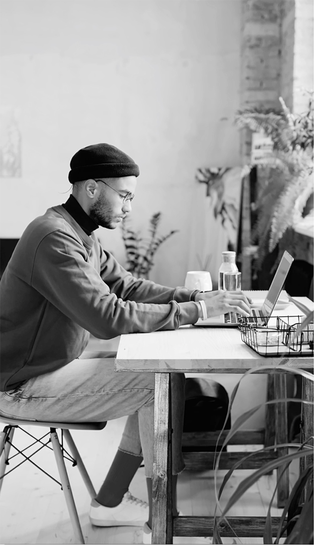 Entrepreneur sitting at desk deciding if they will commission our signature Branding Storytelling service