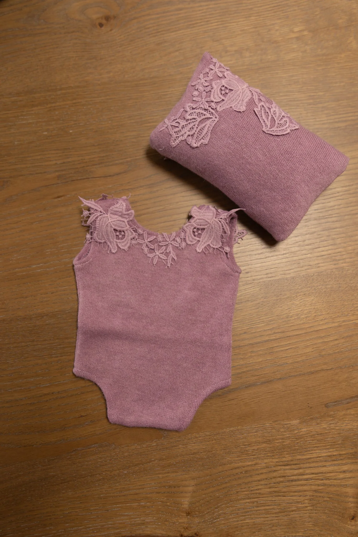 NB - knit onesie in plum w/ pillow