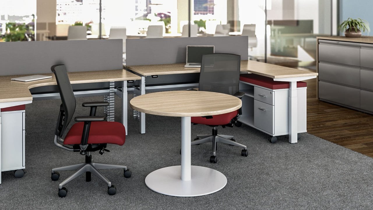 Penumatic height adjustable round meeting table in office area