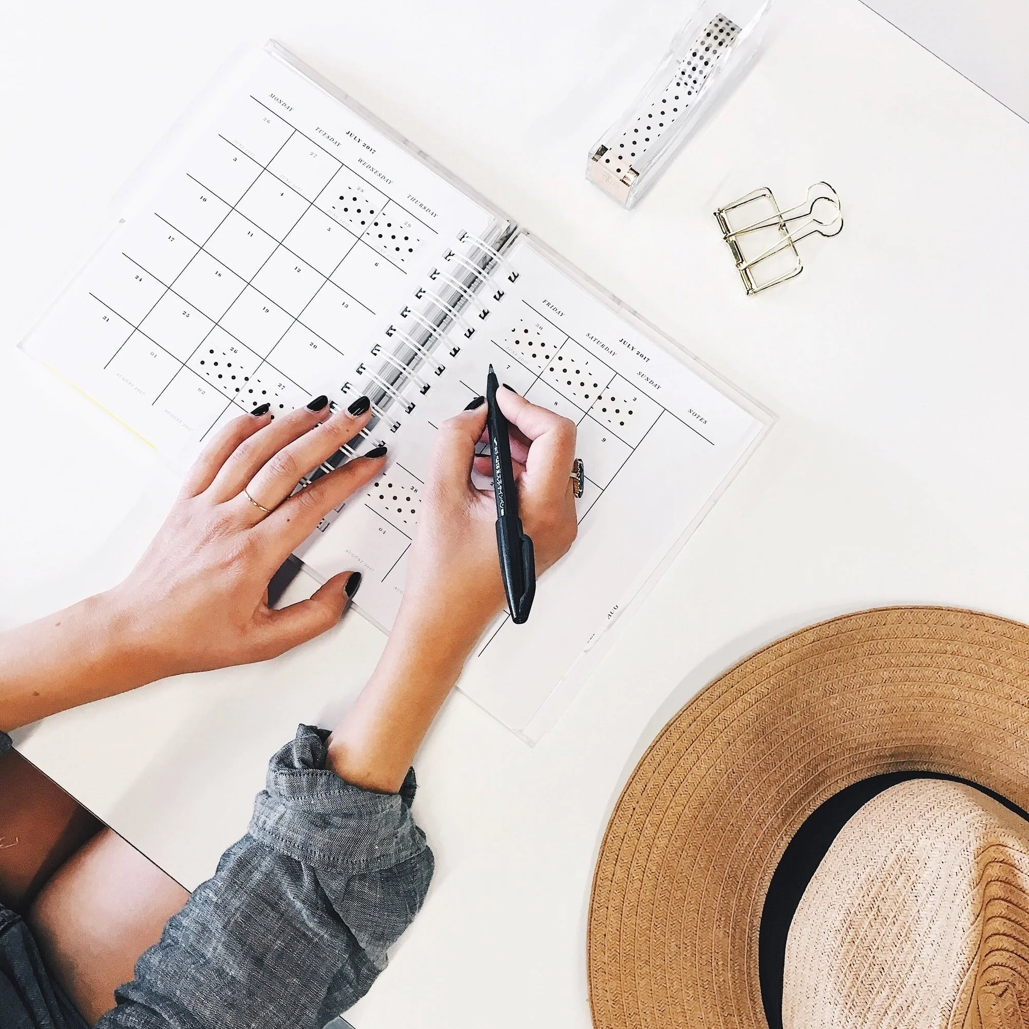 Writing in a calendar for planning a Pinterest marketing strategy for eCommerce shops