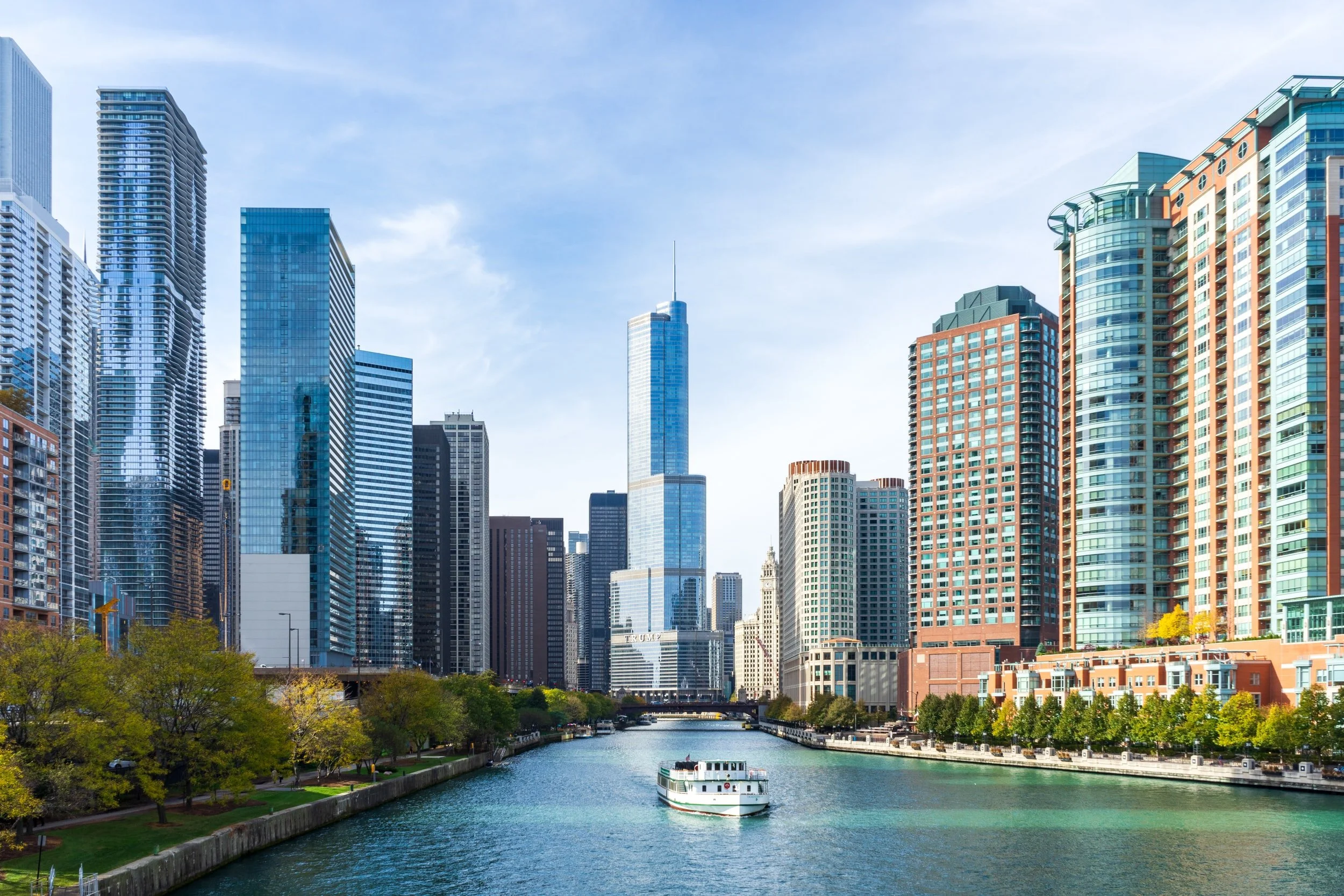 boat crusing down chicago river. people touring chicago.