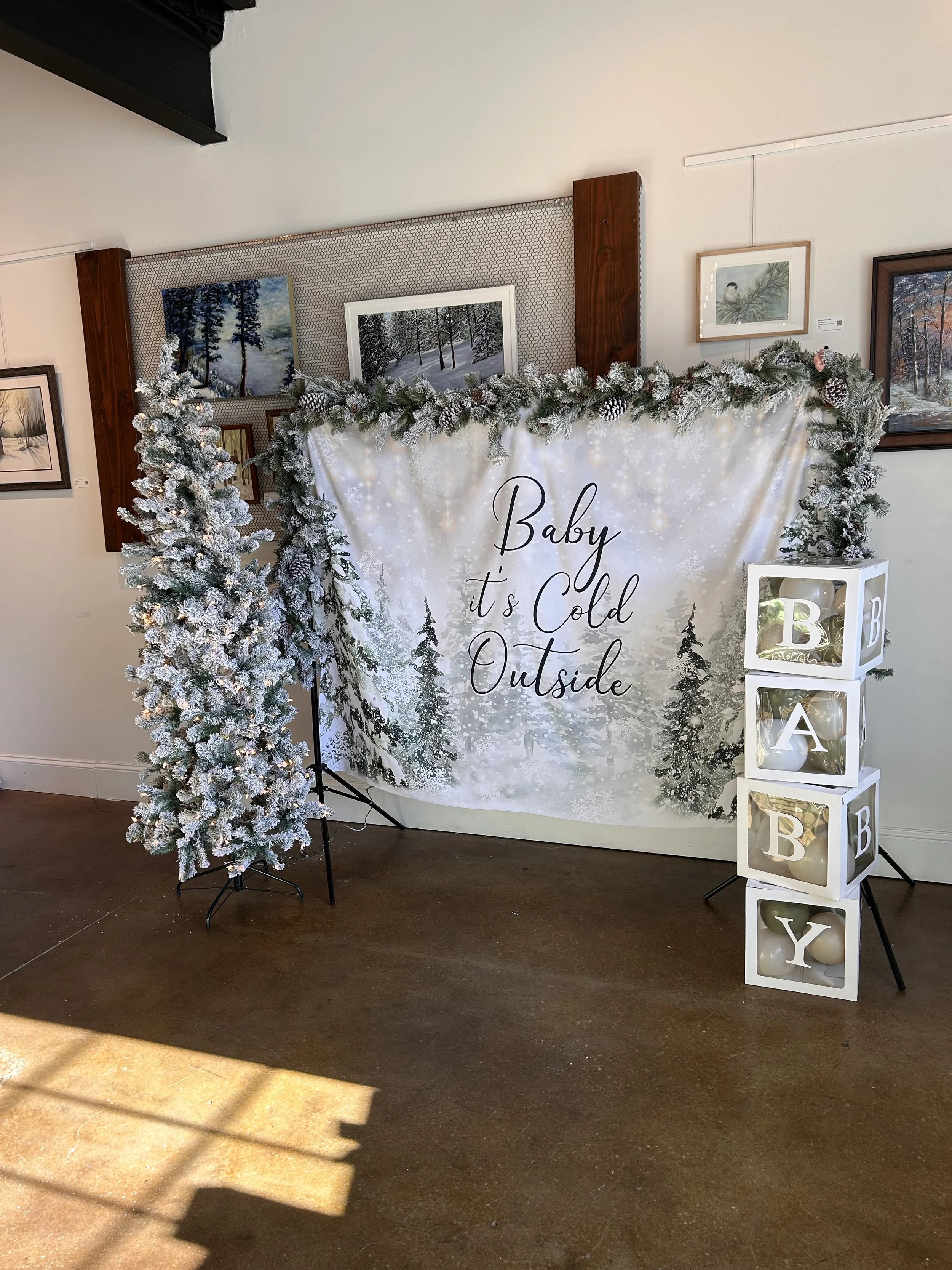 baby its cold outside backdrop. trees and garland to make the backdrop decorated. 