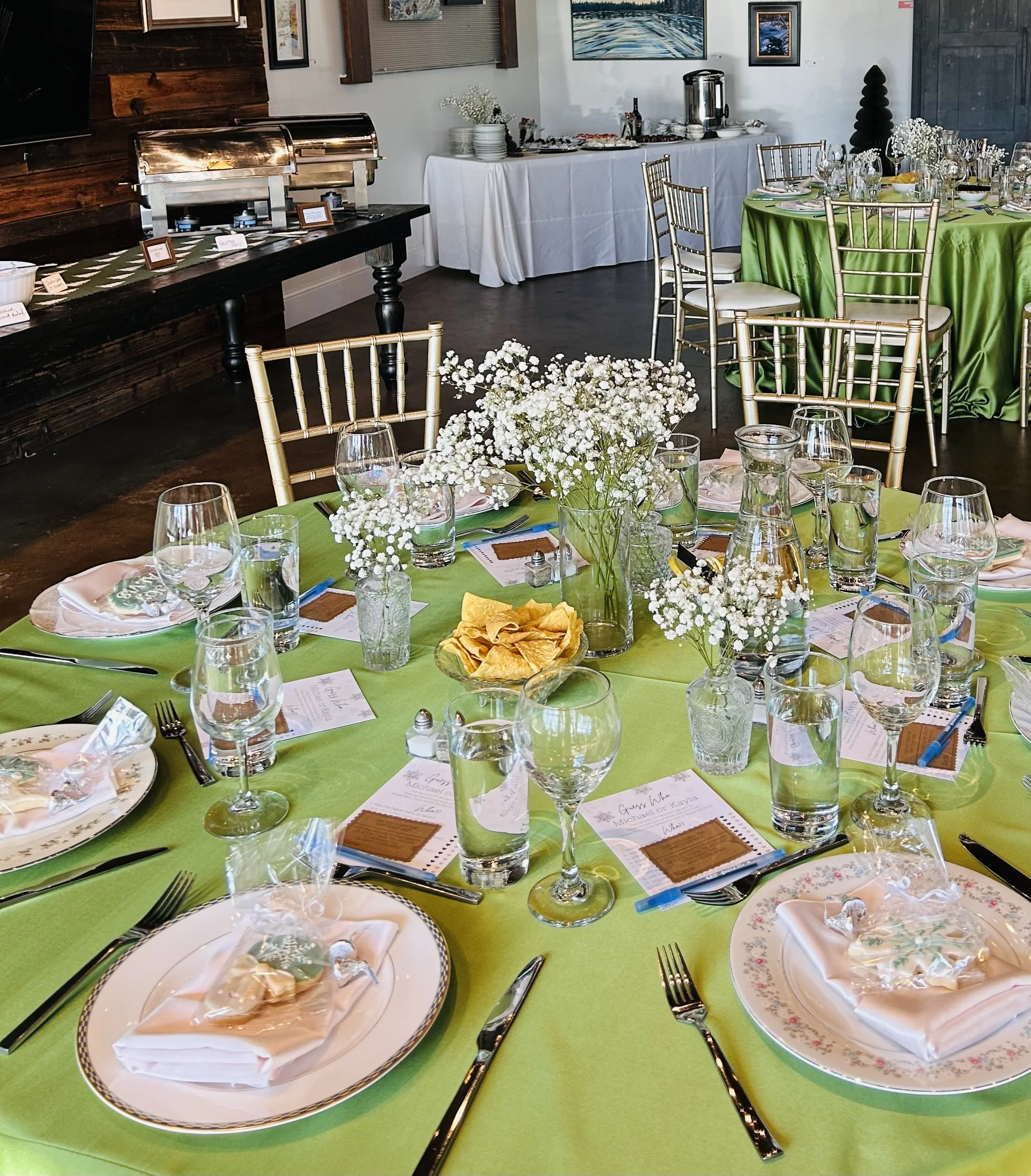 close up table setting for baby shower. green table cloth makes the room pop in the art gallery. perfect setting for a chicago baby shower. 