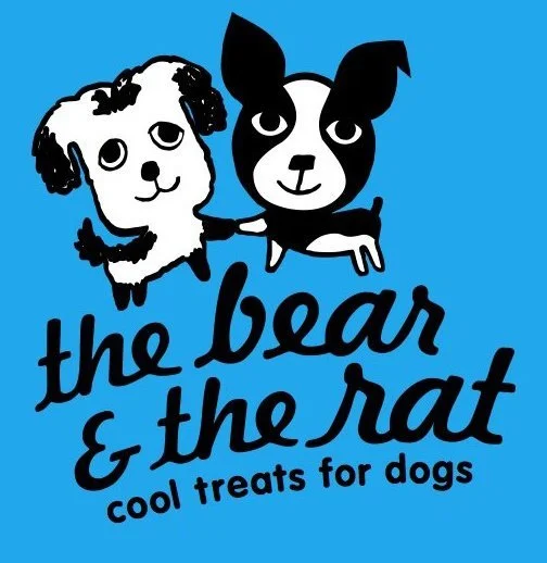 Logo for "The Bear & The Rat," featuring cartoon illustrations of a dog and a rat holding hands, with the tagline "cool treats for dogs" on a blue background.
