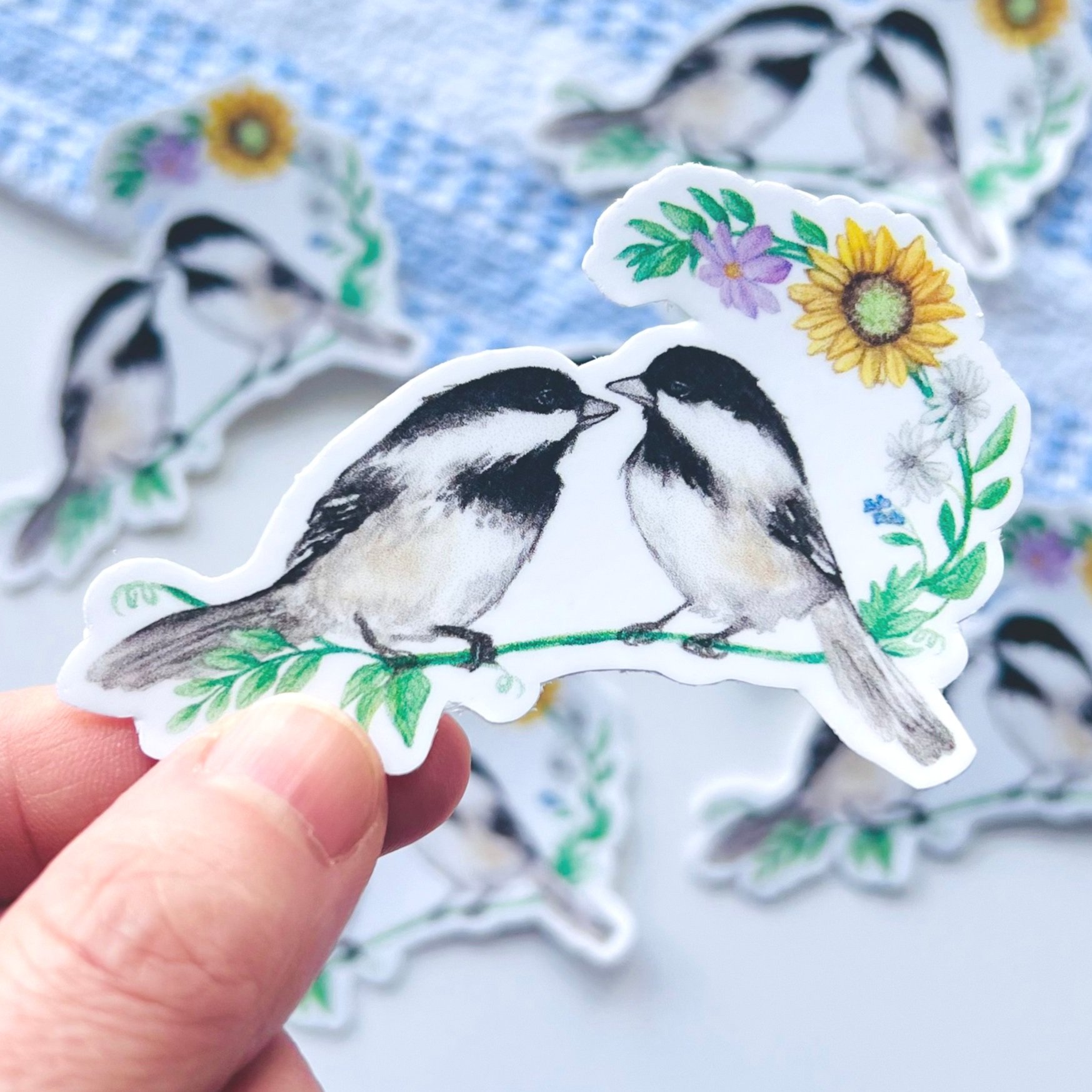 Watercolor Chickadees sitting on a floral branch sticker close up