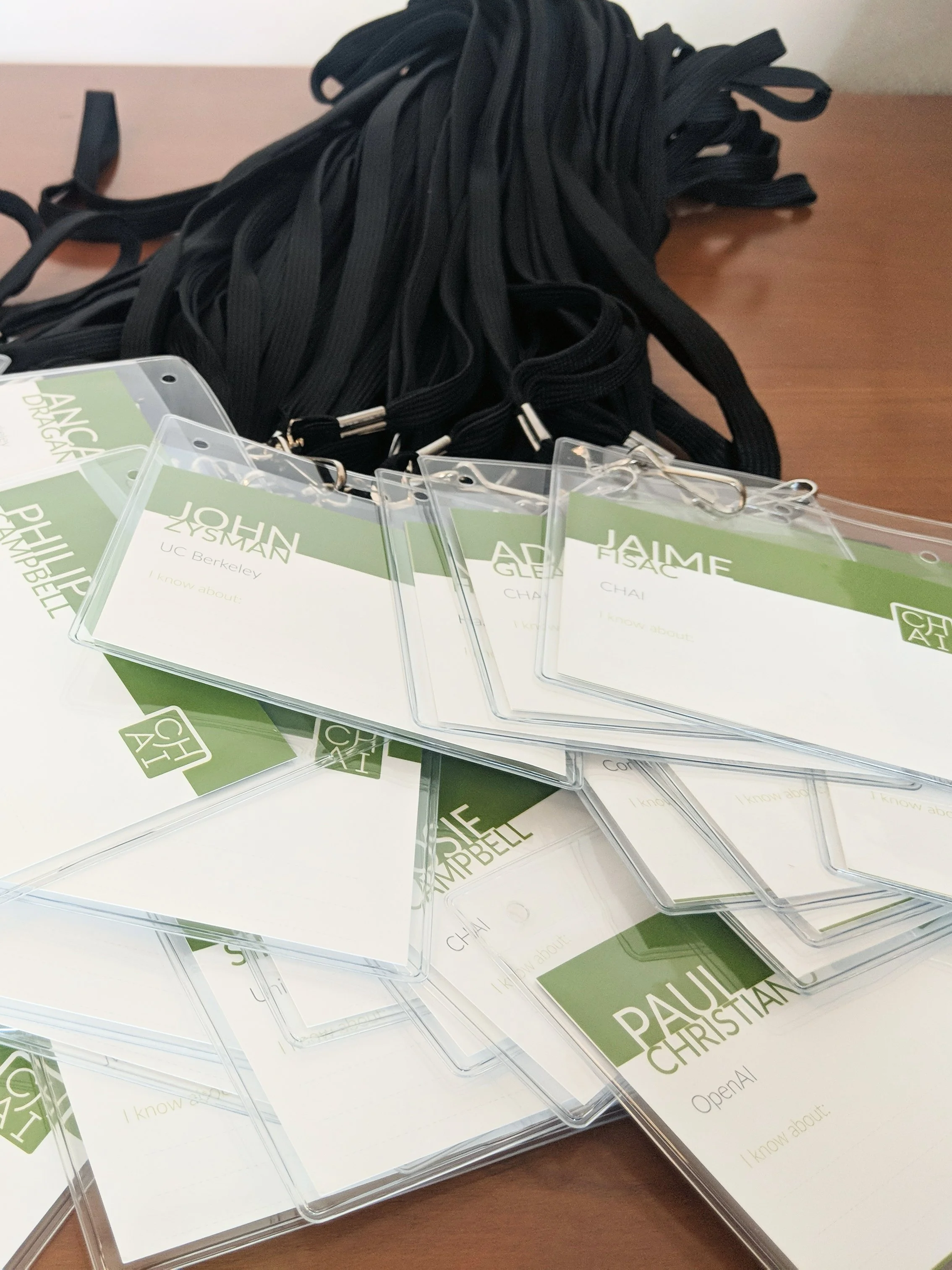 Conference badges featuring the CHAI logomark