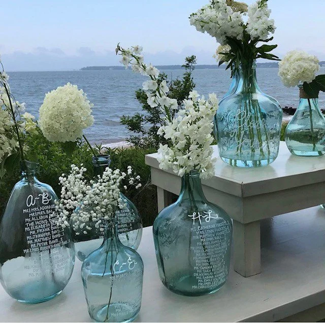 white wedding seating assignment jugs.jpg
