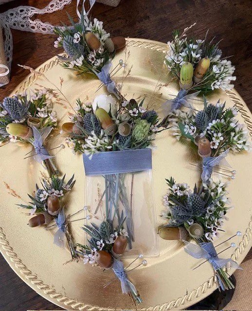 Center pocket boutonniere fits into groom's breast pocket with matching pin-on bouts for his wedding party.jpg