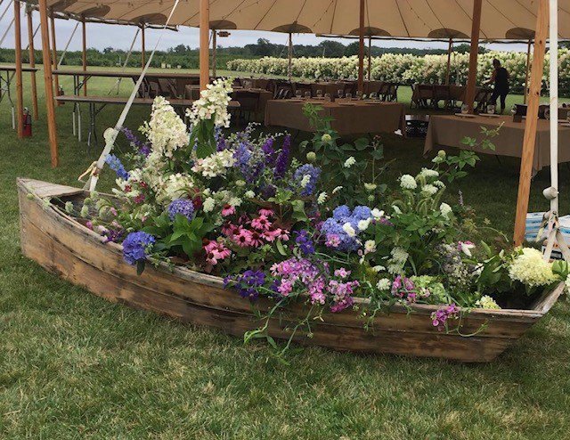 Large cocktail hour row boat floral display.jpg