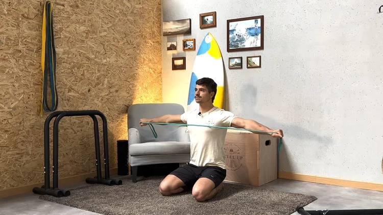 A surfer doing a mobility test on a mat in a home gym