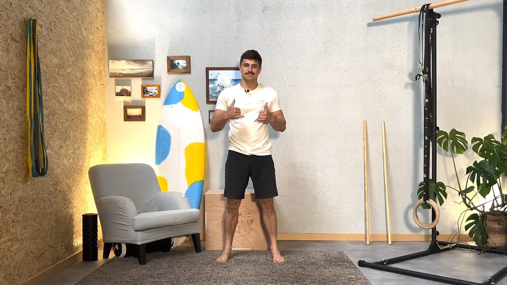 Coach Keith in his home training studio, surfboard and equipment behind him