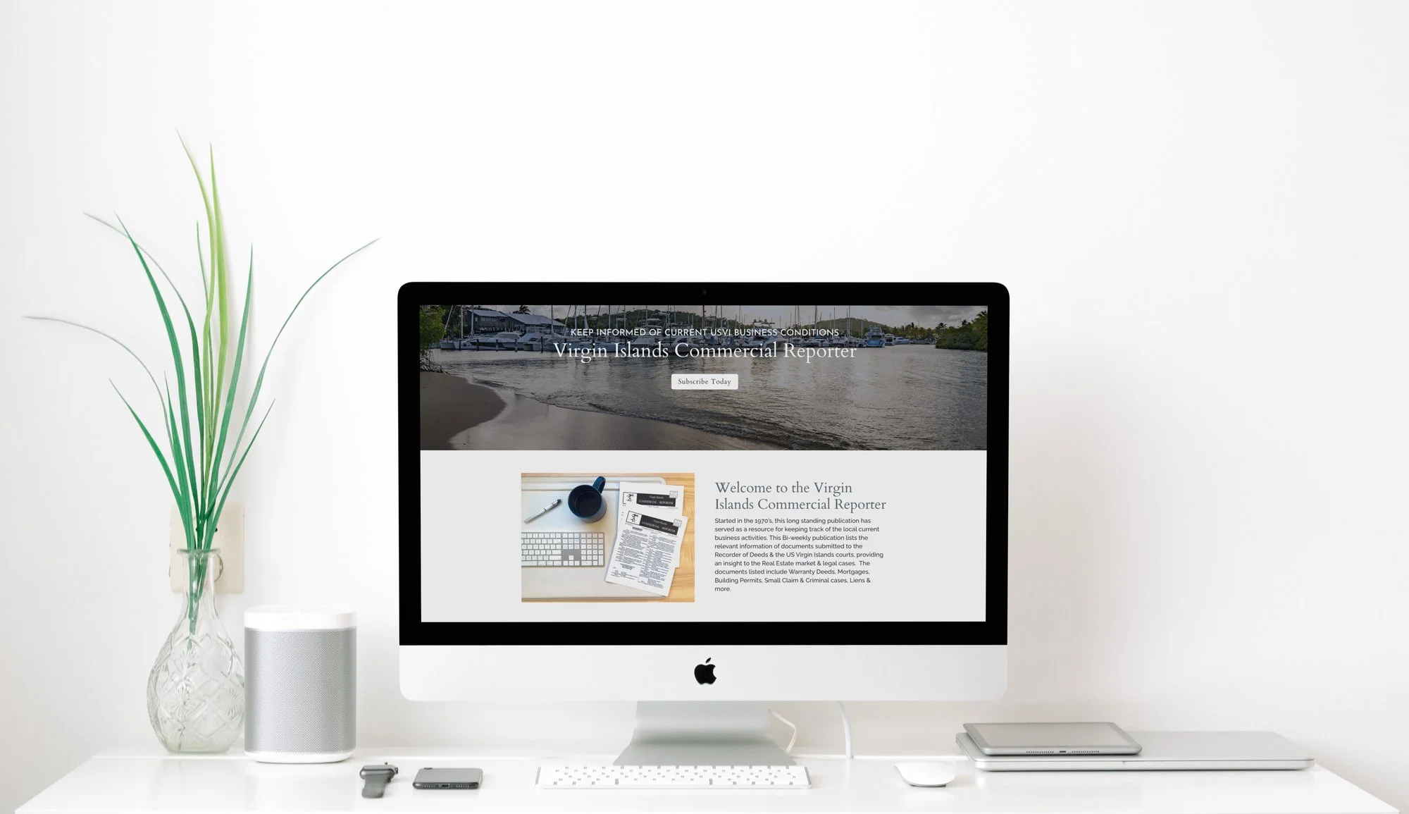 Commercial Reporter website displayed on imac on white desk