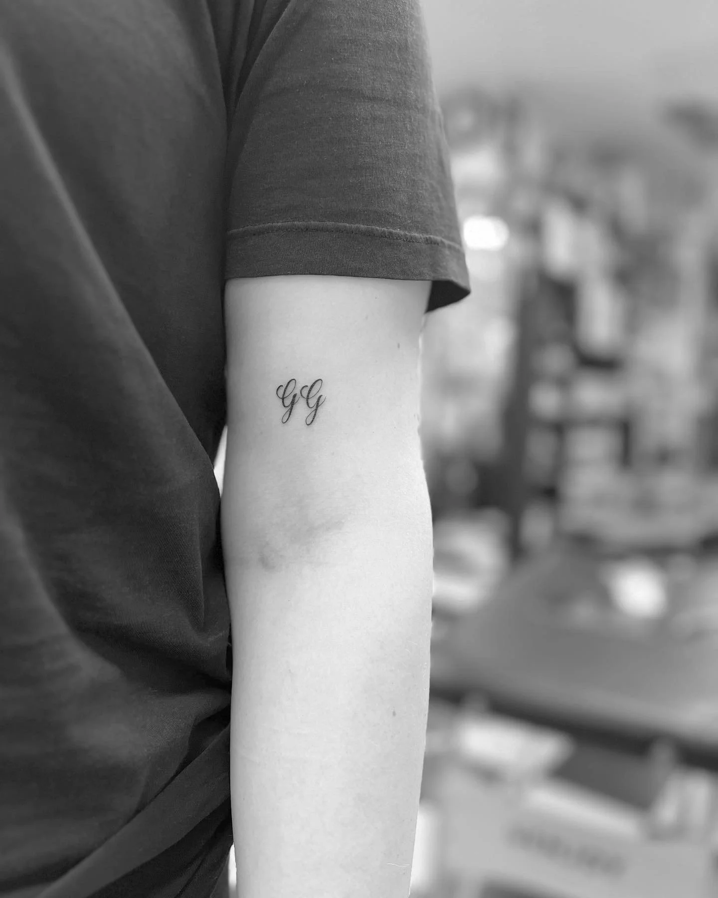 Simple script initials tattoo