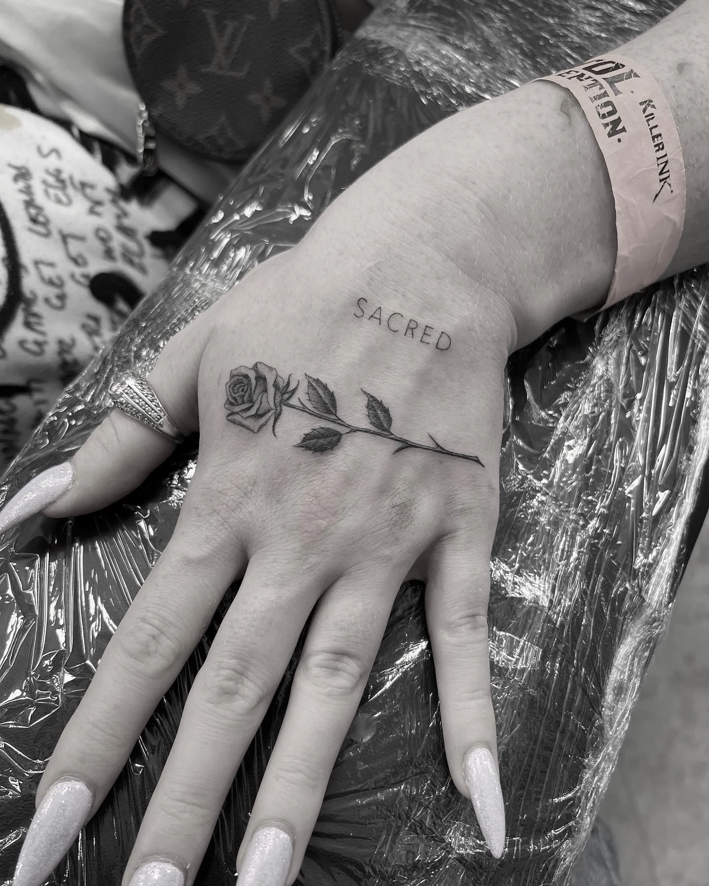 Fineline rose and fineline simple script tattoo hand tattoo