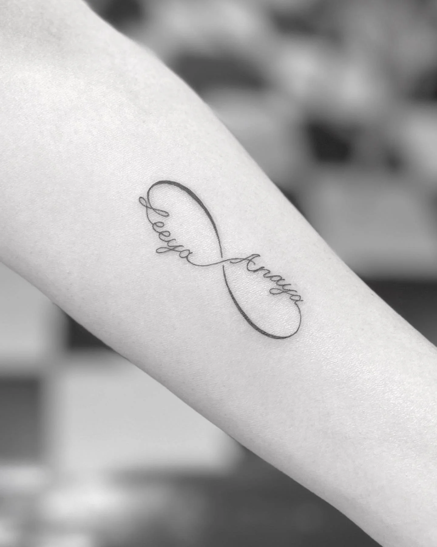 Infinity symbol fineline tattoo