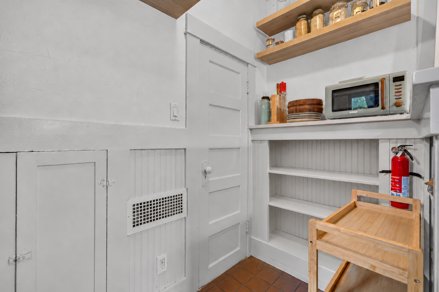 Bare wooden stand beside fire extinguisher.png