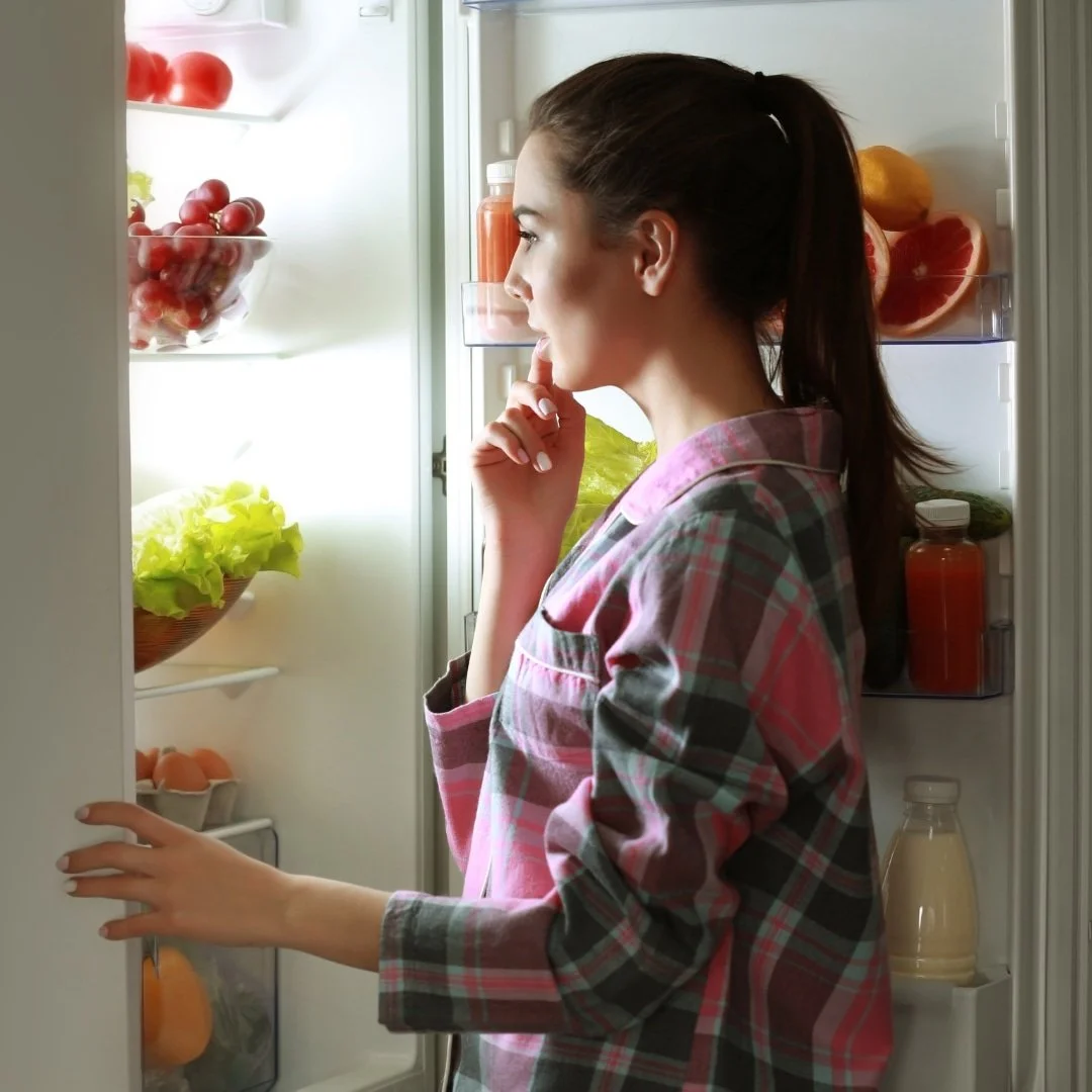 Woman looking inside a refrigerator