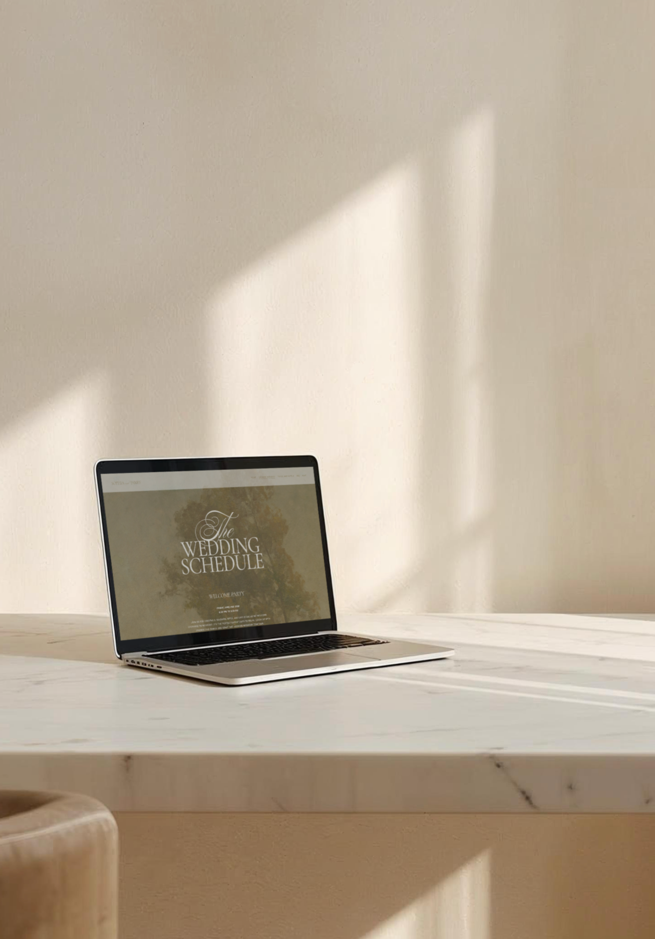 Open laptop on a white marble table displaying a wedding schedule.