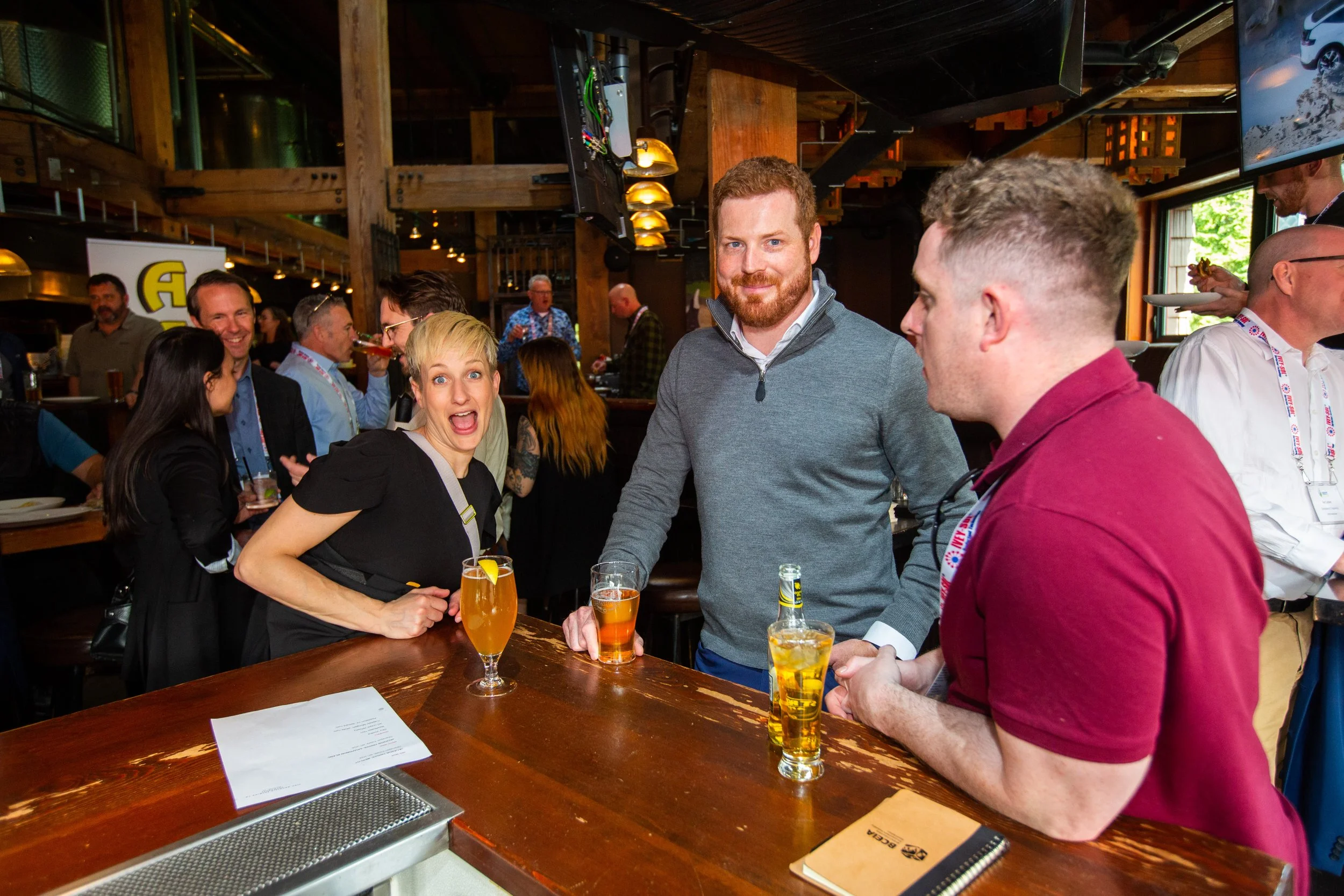 People socializing in a bar with drinks on the table.