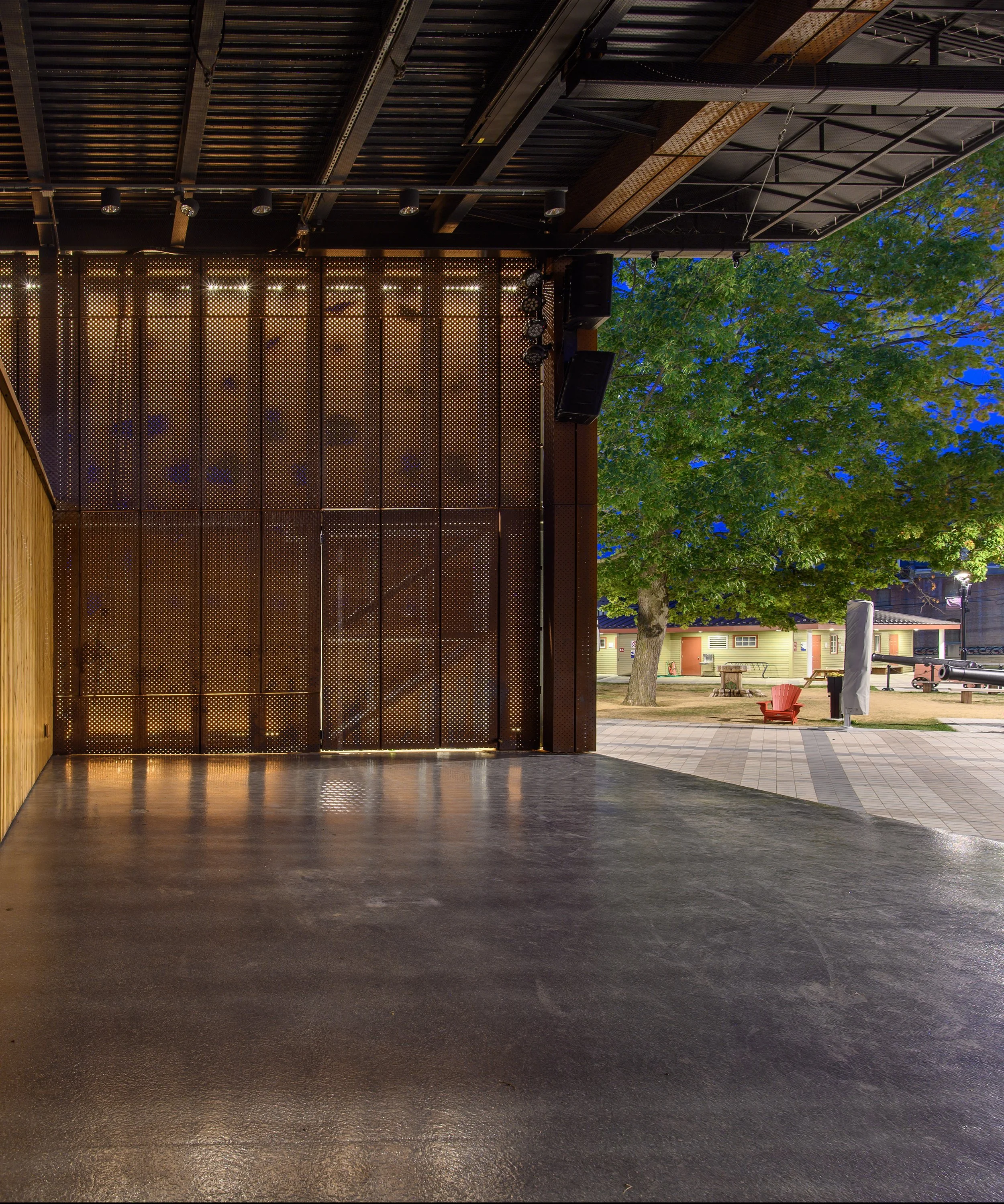 Custom perforated COR-TEN weathering steel facade on the Garrison Stage civic pavilion in Fredericton, New Brunswick.