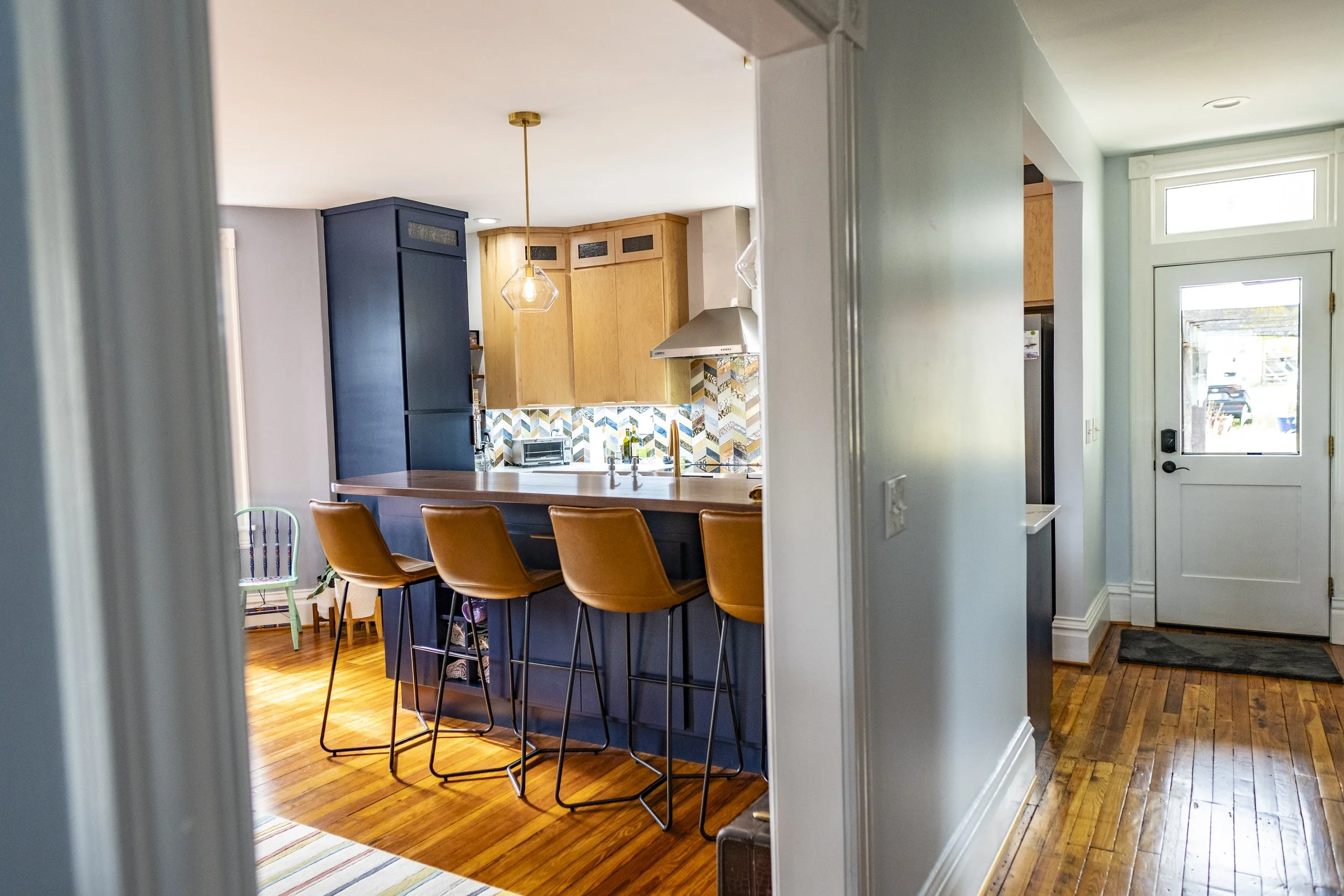 View into the renovated kitchen from the opened up hallway.