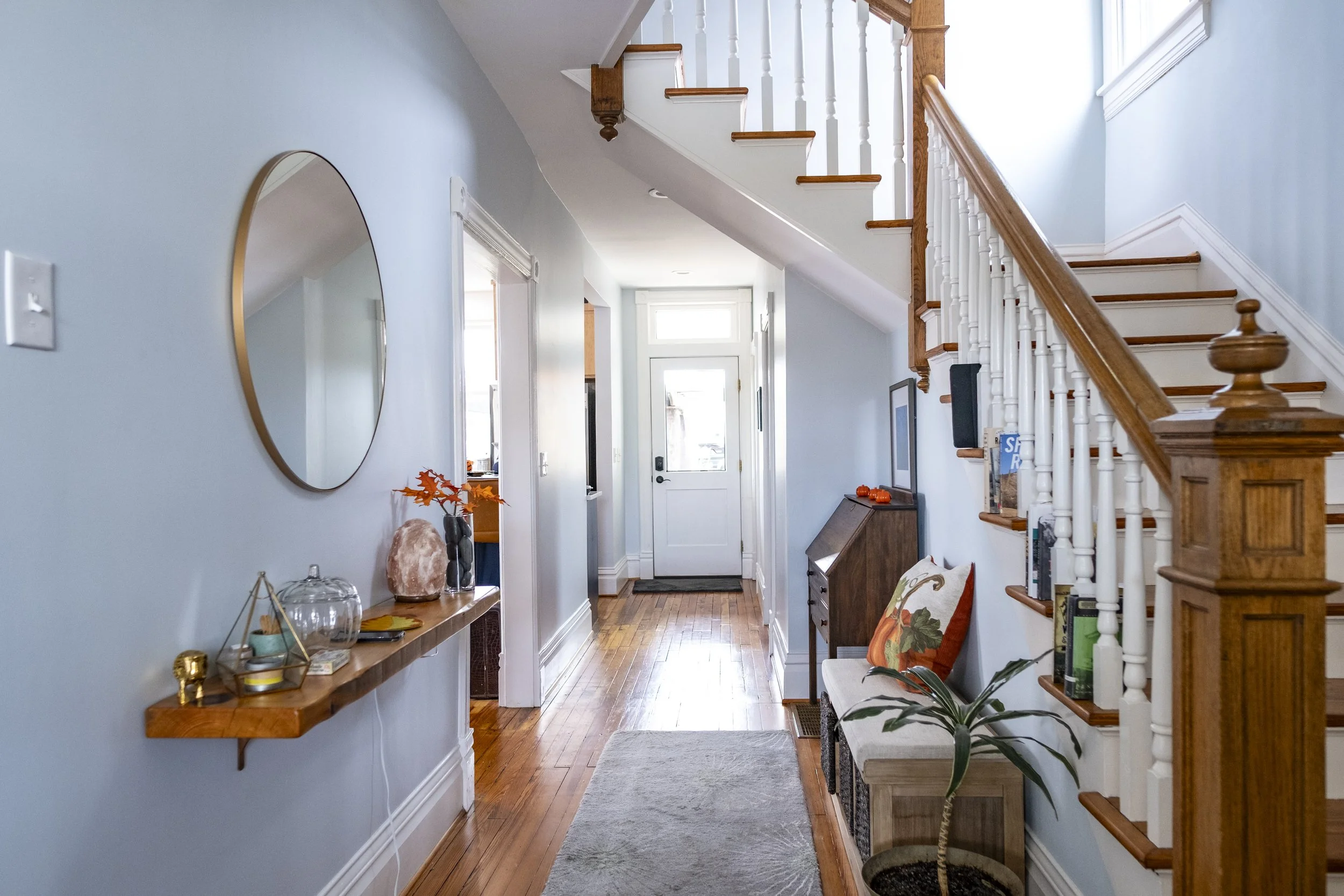 Entryway shows where parts of the wall on the left were taken out to open up the hallway.