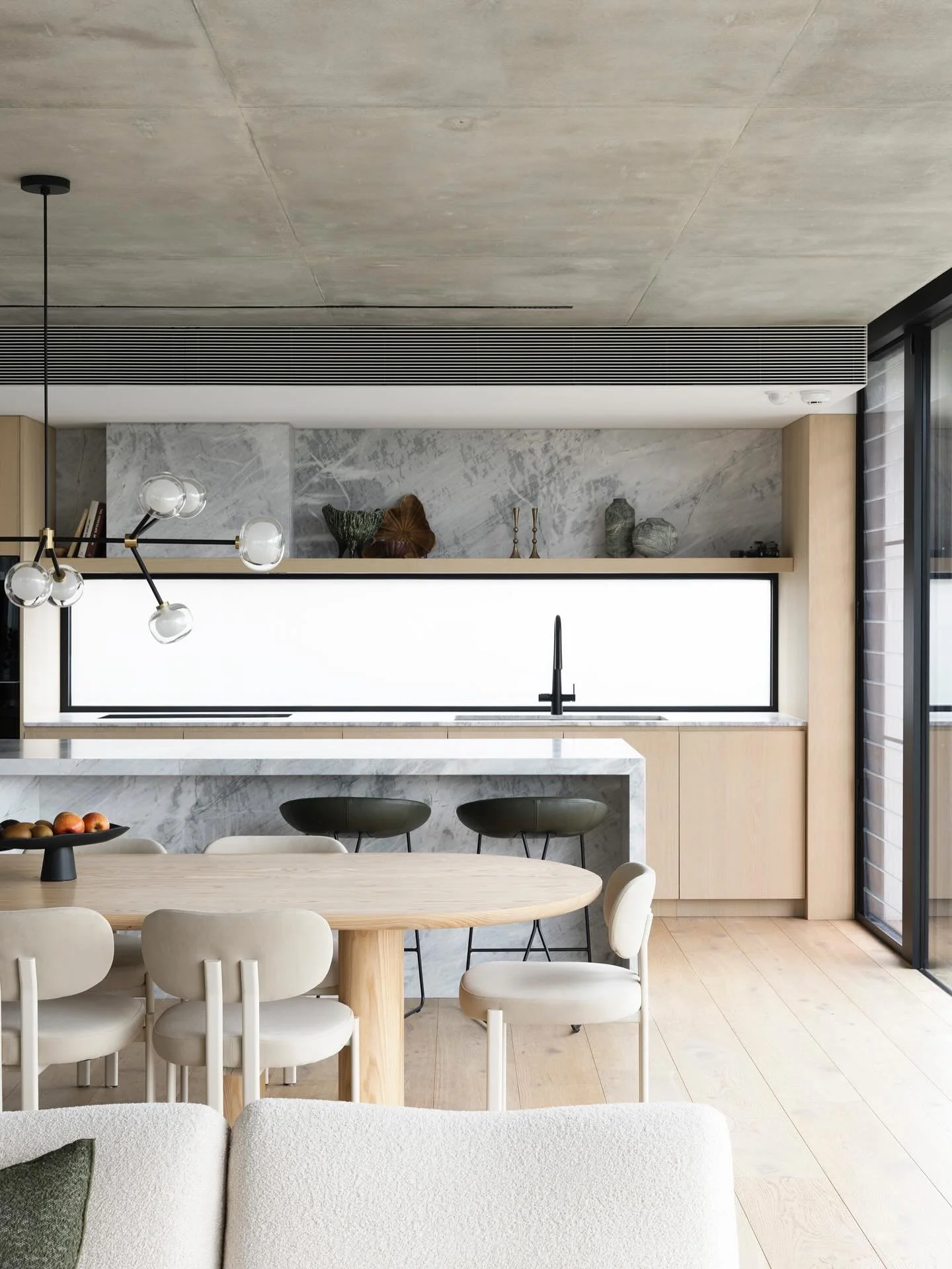 The kitchen at our Seaforth 02 project, seamlessly integrated with the living/ dining and outdoor entertaining areas. Built by @mink_building_group Styling by @lxjcreativestudio Lighting by @wildly_illuminating Photos by @simonwhitbreadphoto #watersh