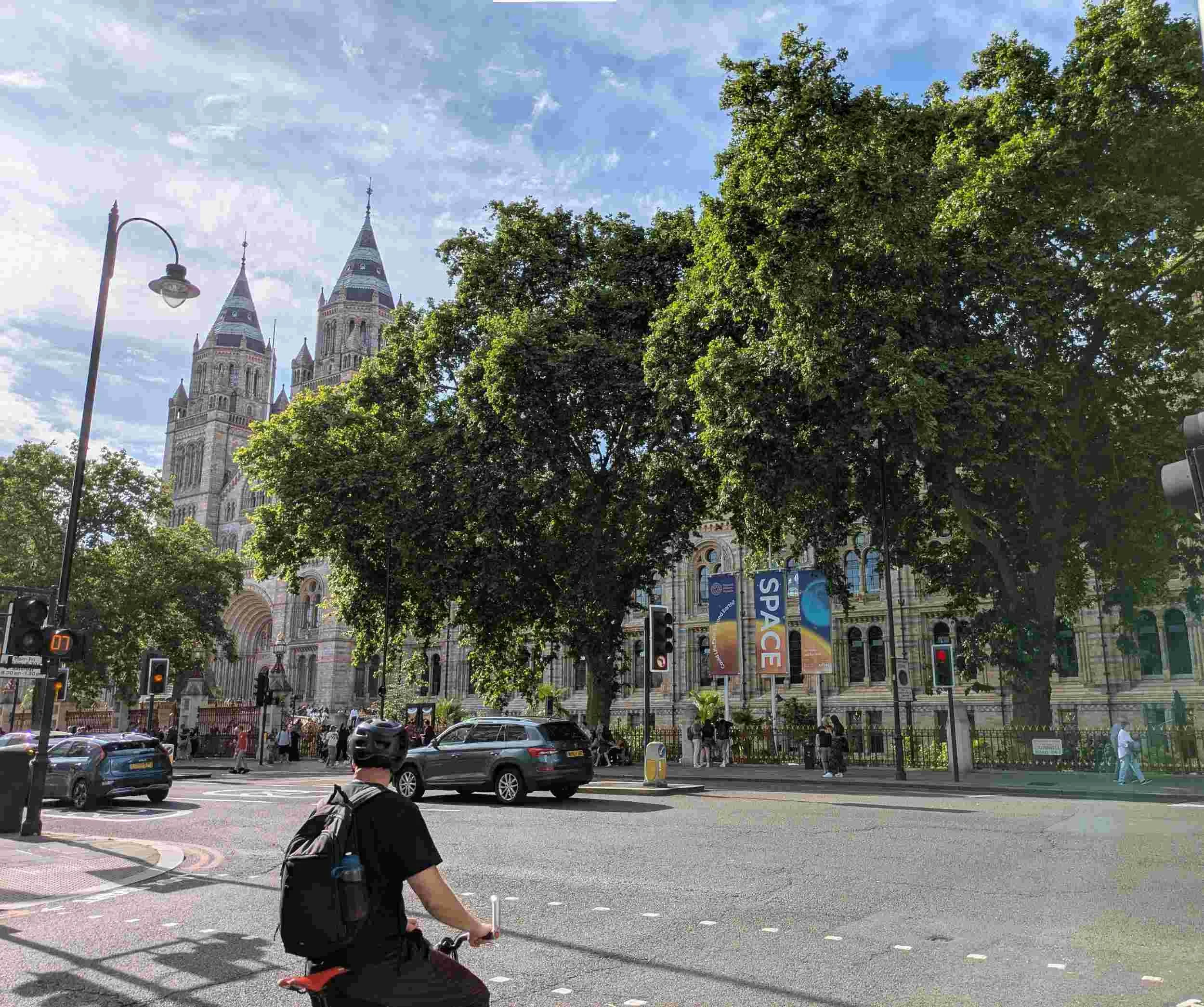 Gothic style Natural History Museum exterior with trees in full leaf