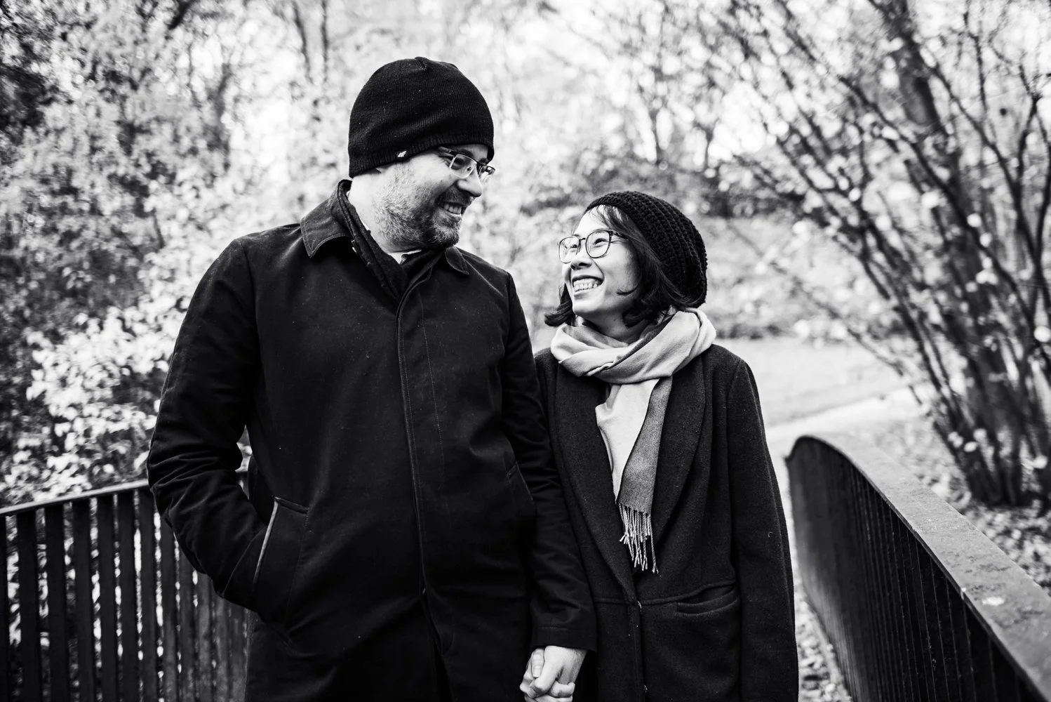 séance couple futurs mariés se regardent et sourient en hiver parc.jpg