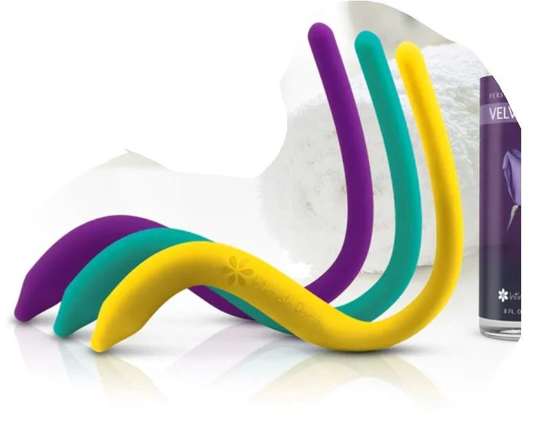 Four colorful curved objects in purple, teal, yellow, and purple along with a can of velvety spray and a jar of fluffy white substance.