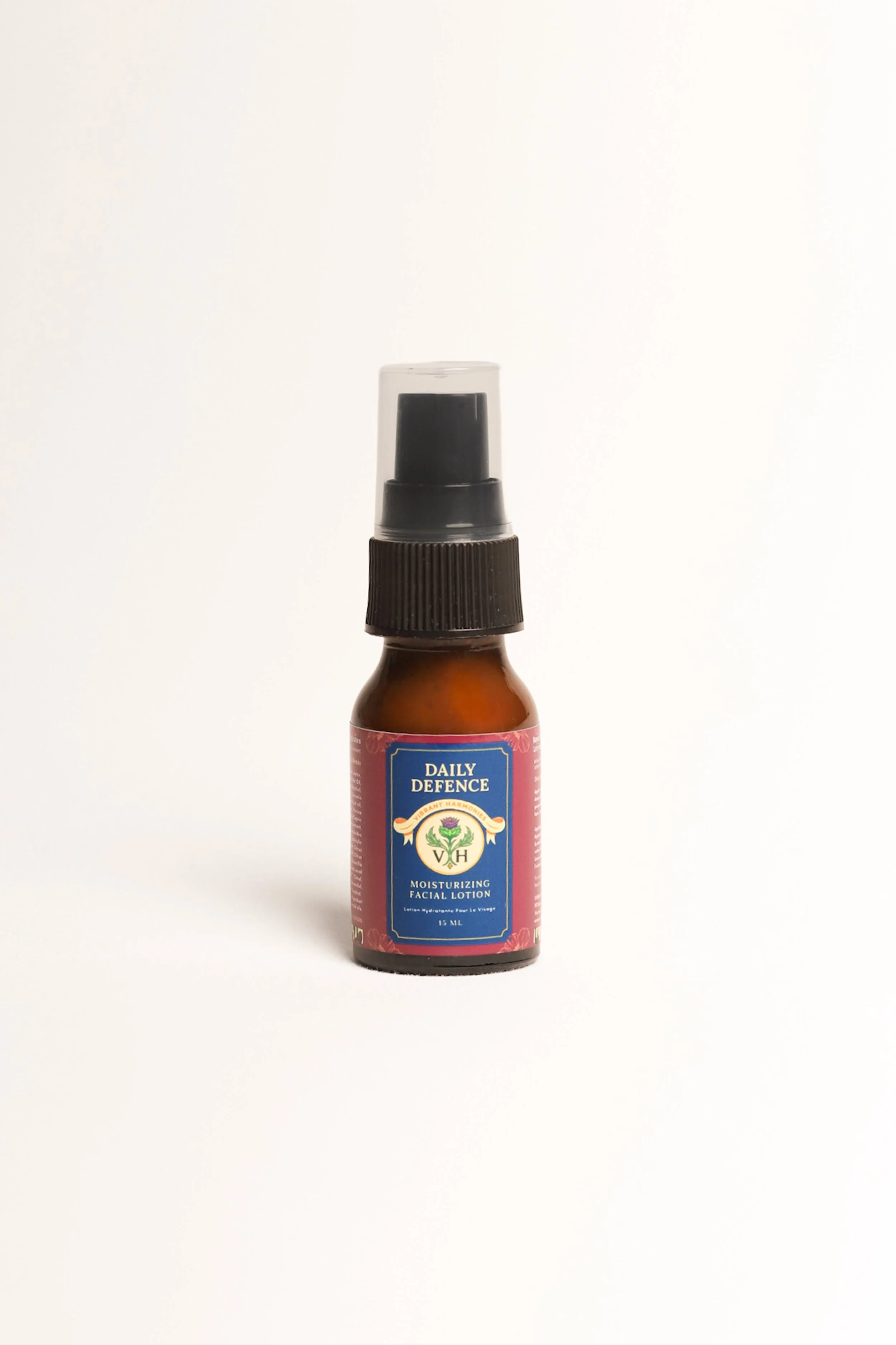 A brown bottle with a black spray nozzle, labeled "Daily Defence" moisturizing facial lotion, standing against a plain white background.