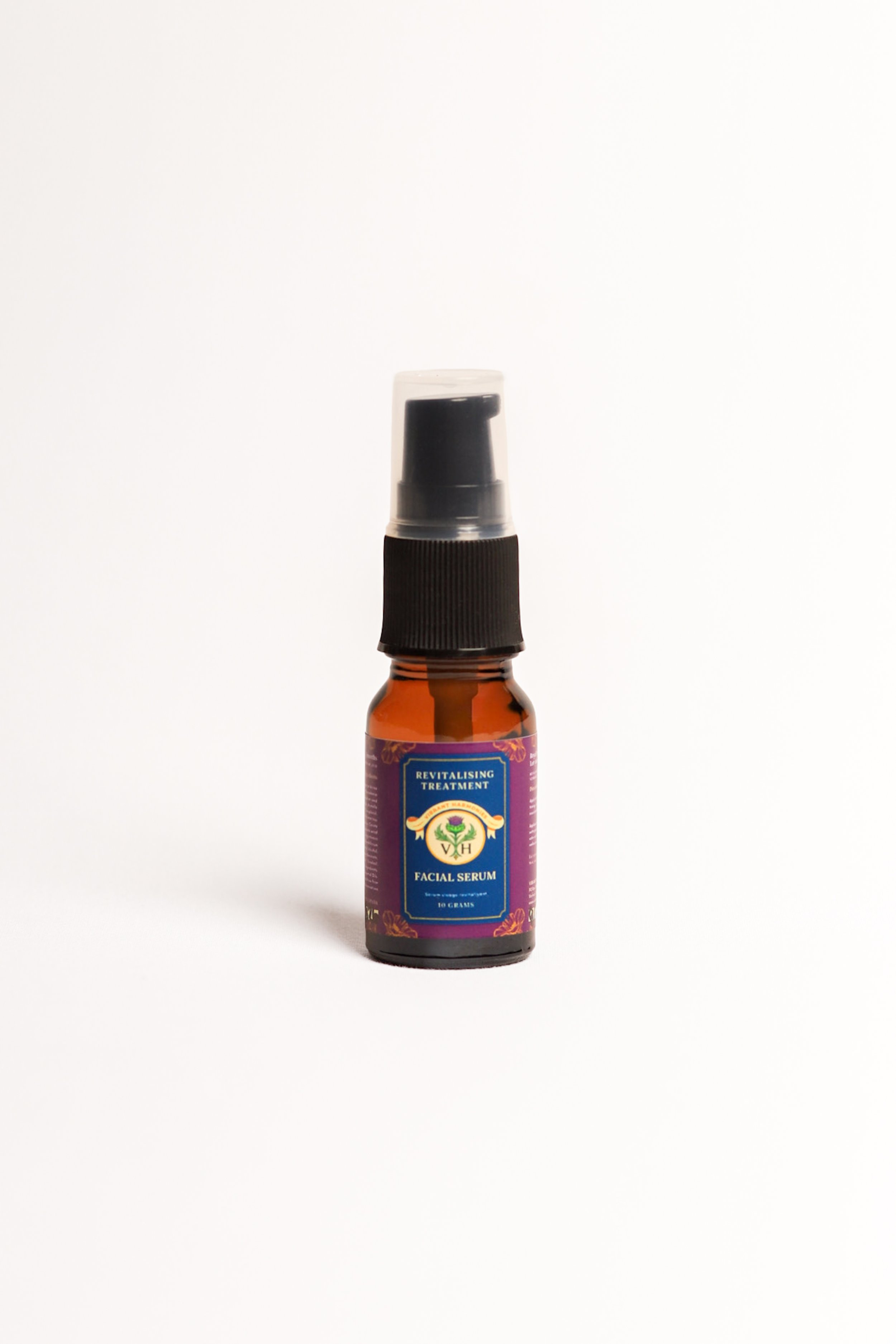 Bottle of facial serum with a spray nozzle, label indicates 'Revitalising Treatment' and 'Facial Serum'